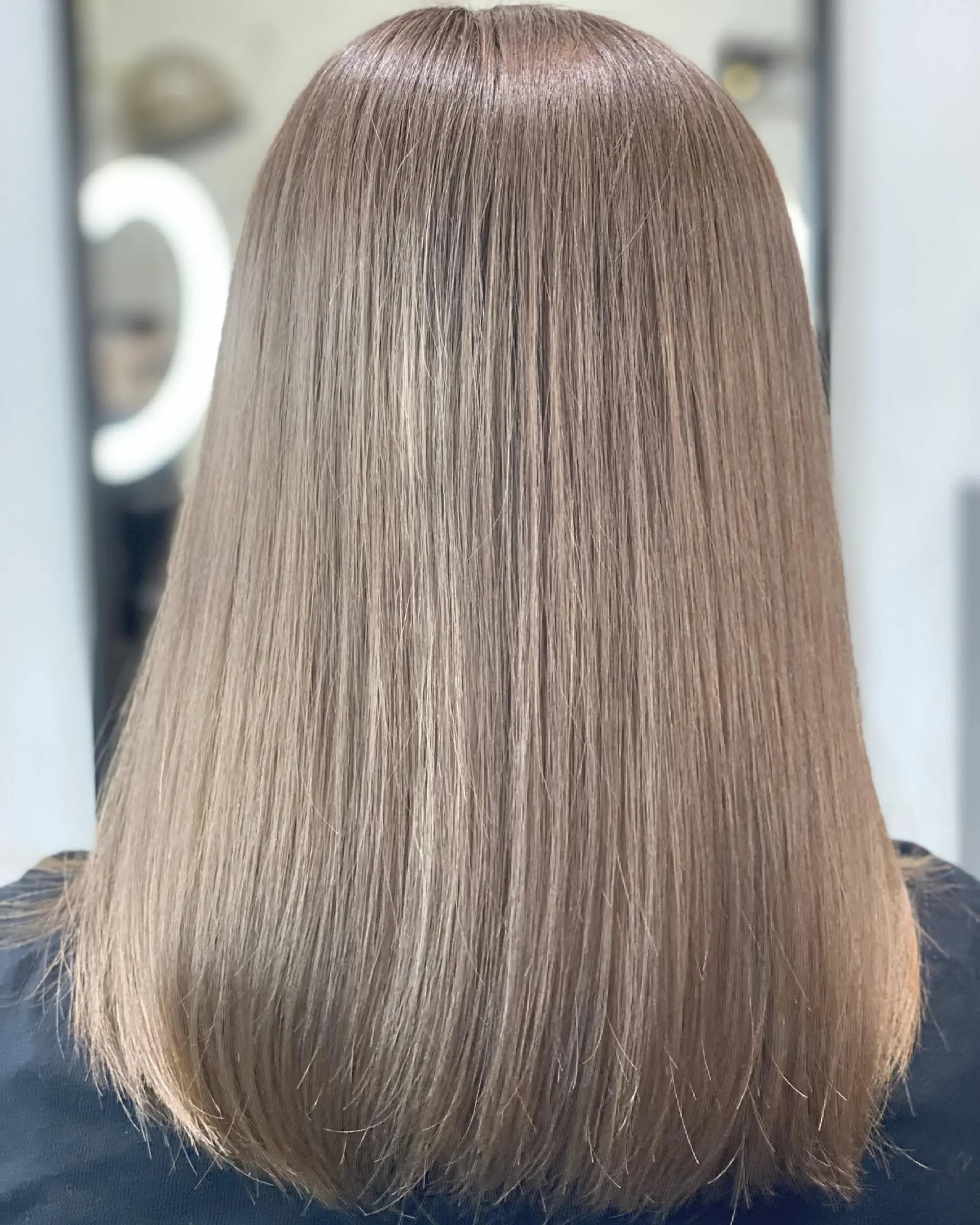 Long, straight hair in a trendy ash blonde shade. 1