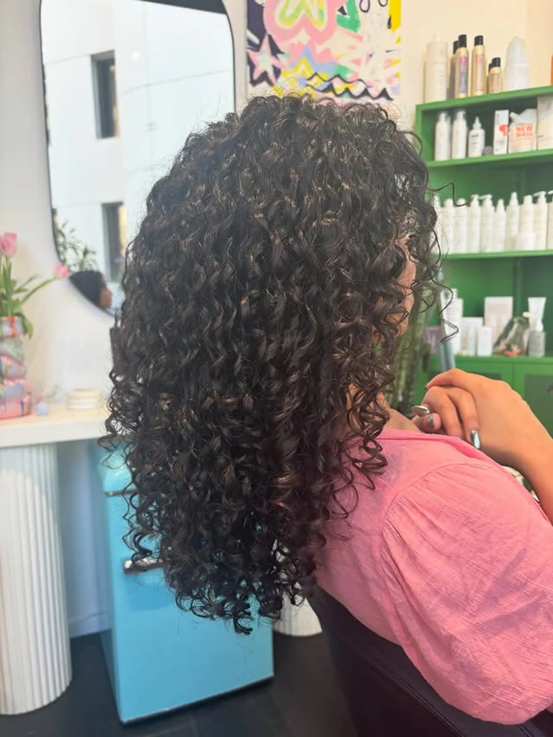 Long layered curly hairstyle with defined curls. 1