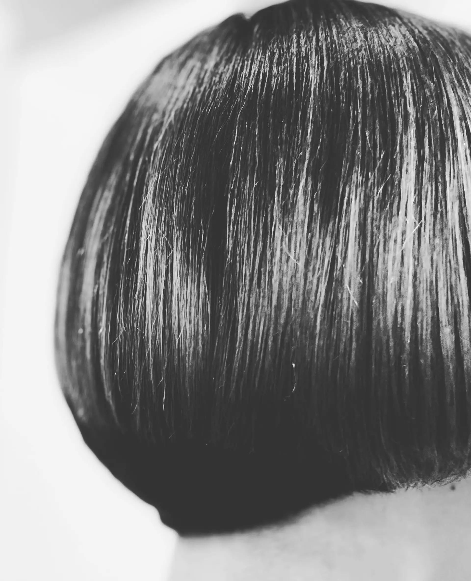 A sleek, precision-cut classic short bob showing clean architectural lines at the back. 1