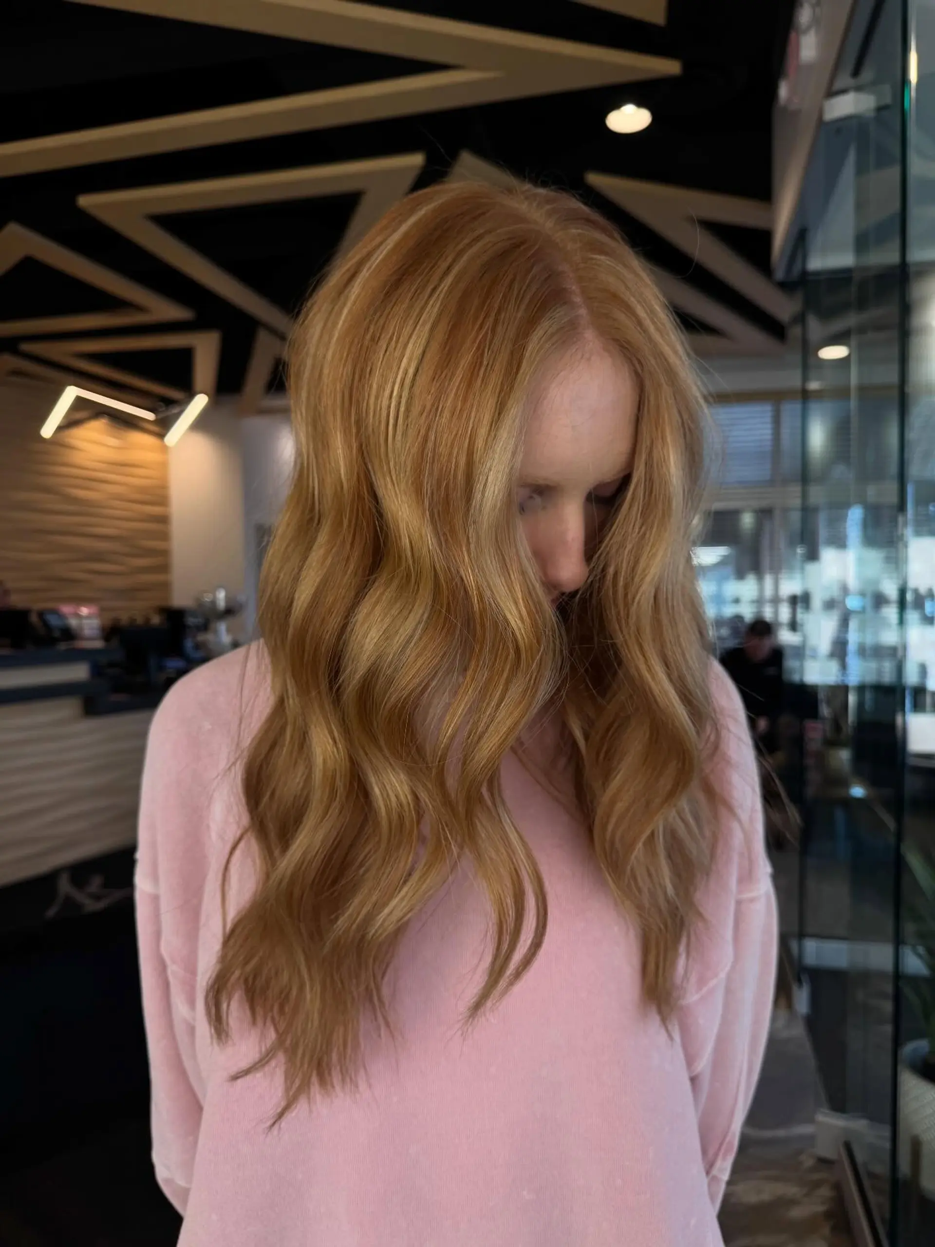Long strawberry copper hair detailed with warm blonde highlights and styled in soft, loose waves. 1