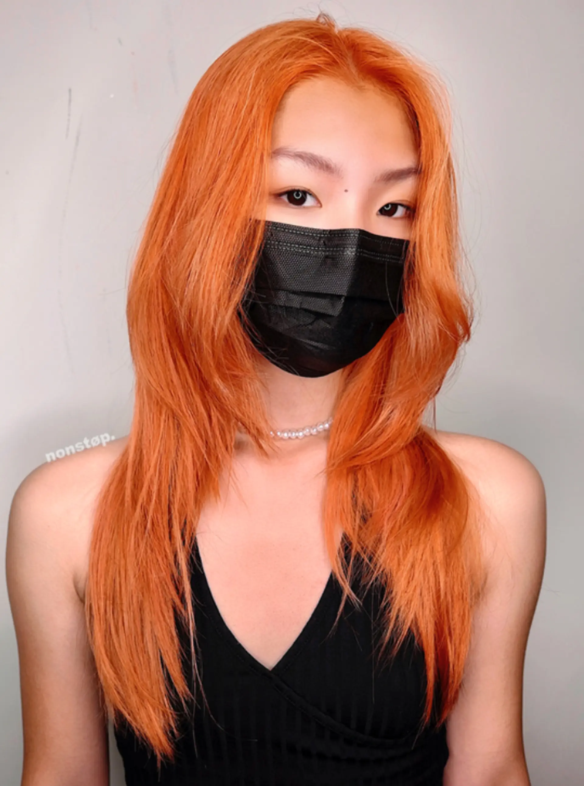 Long, straight, vibrant orange hair with layers for texture and volume. A middle part divides the hair, allowing layers to frame the face. 1