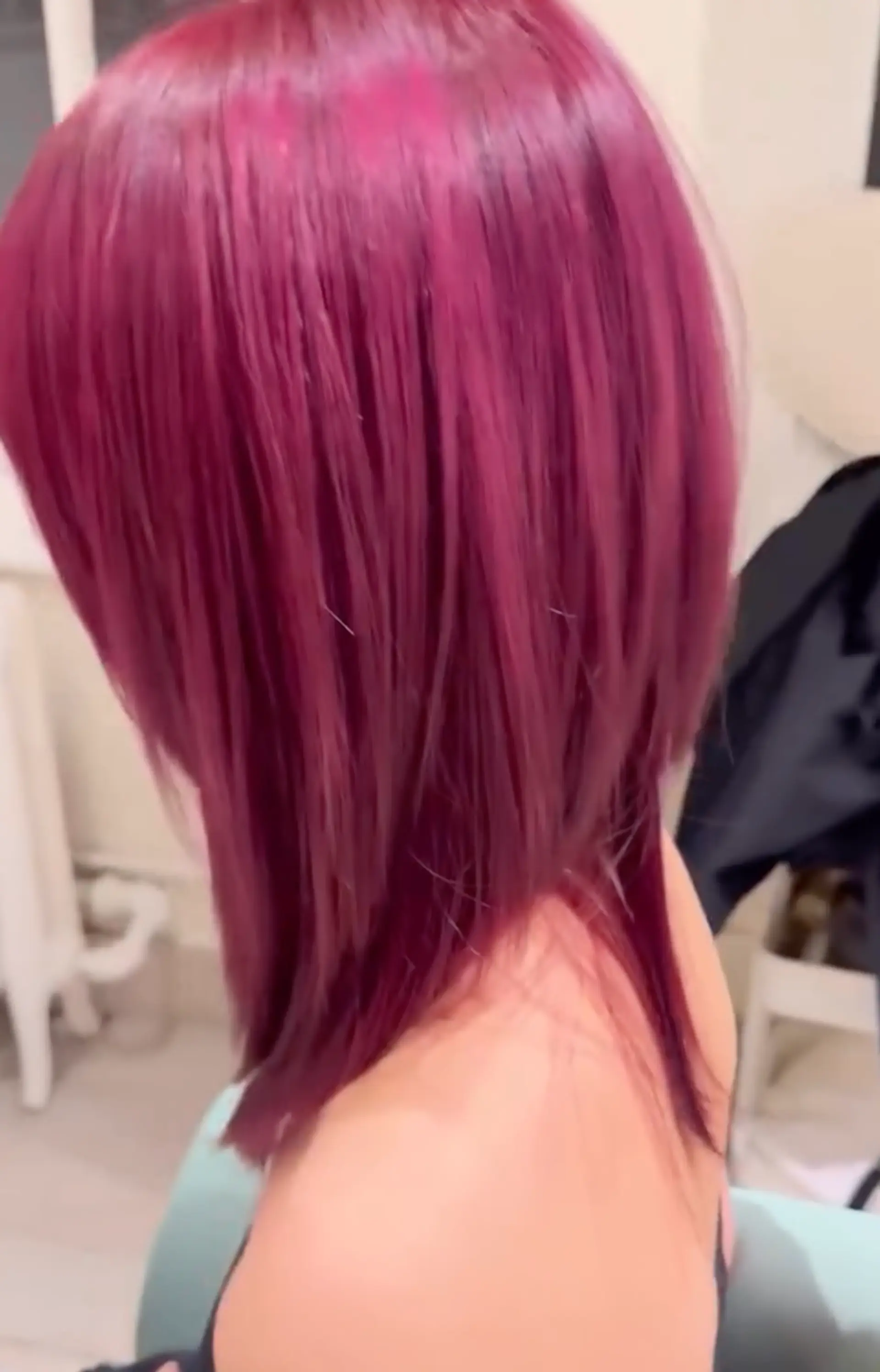 Medium-length straight hair in vibrant red-magenta, styled with precise layers and blunt ends, featuring a shiny finish. 2