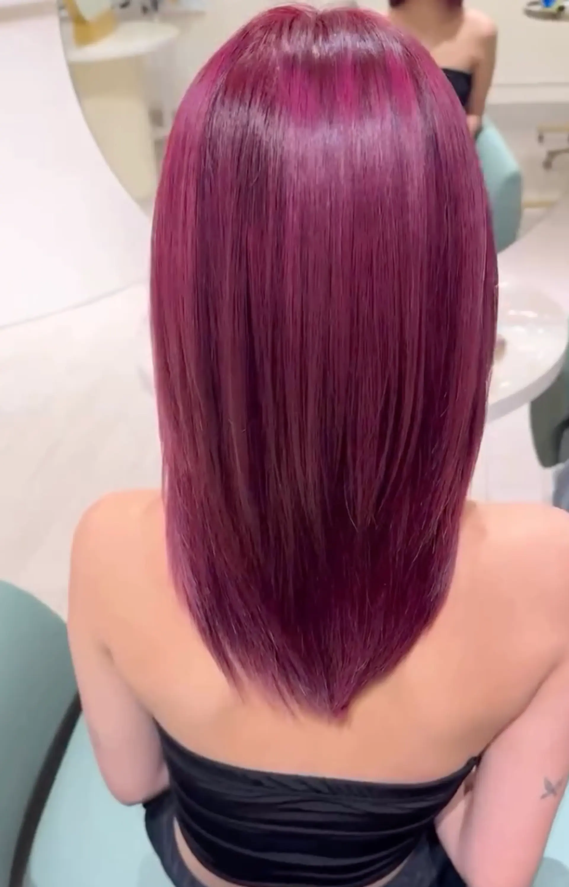 Medium-length straight hair in vibrant red-magenta, styled with precise layers and blunt ends, featuring a shiny finish. 1