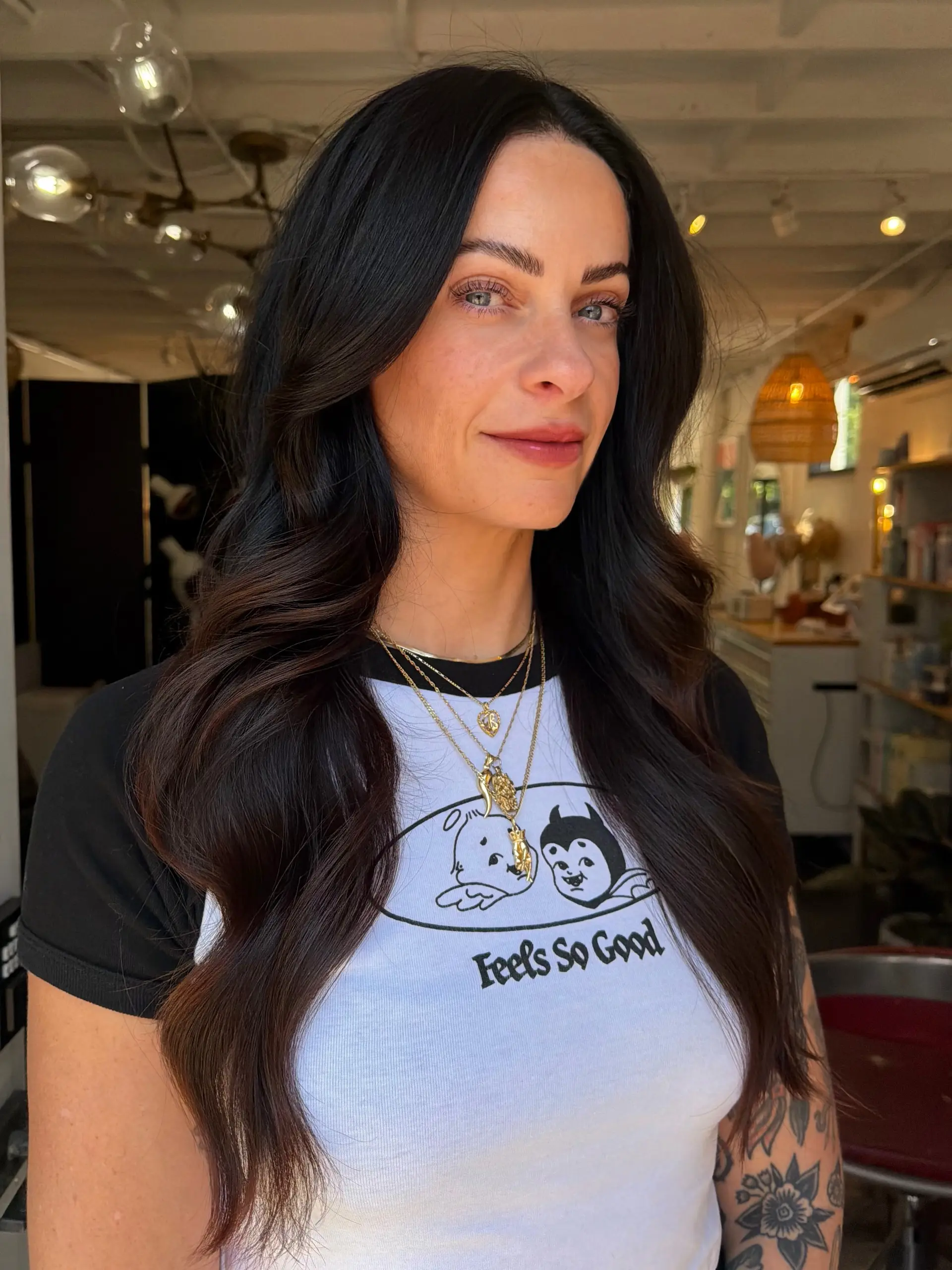 Long, glossy espresso hair styled in soft, cascading waves with a center part. 1