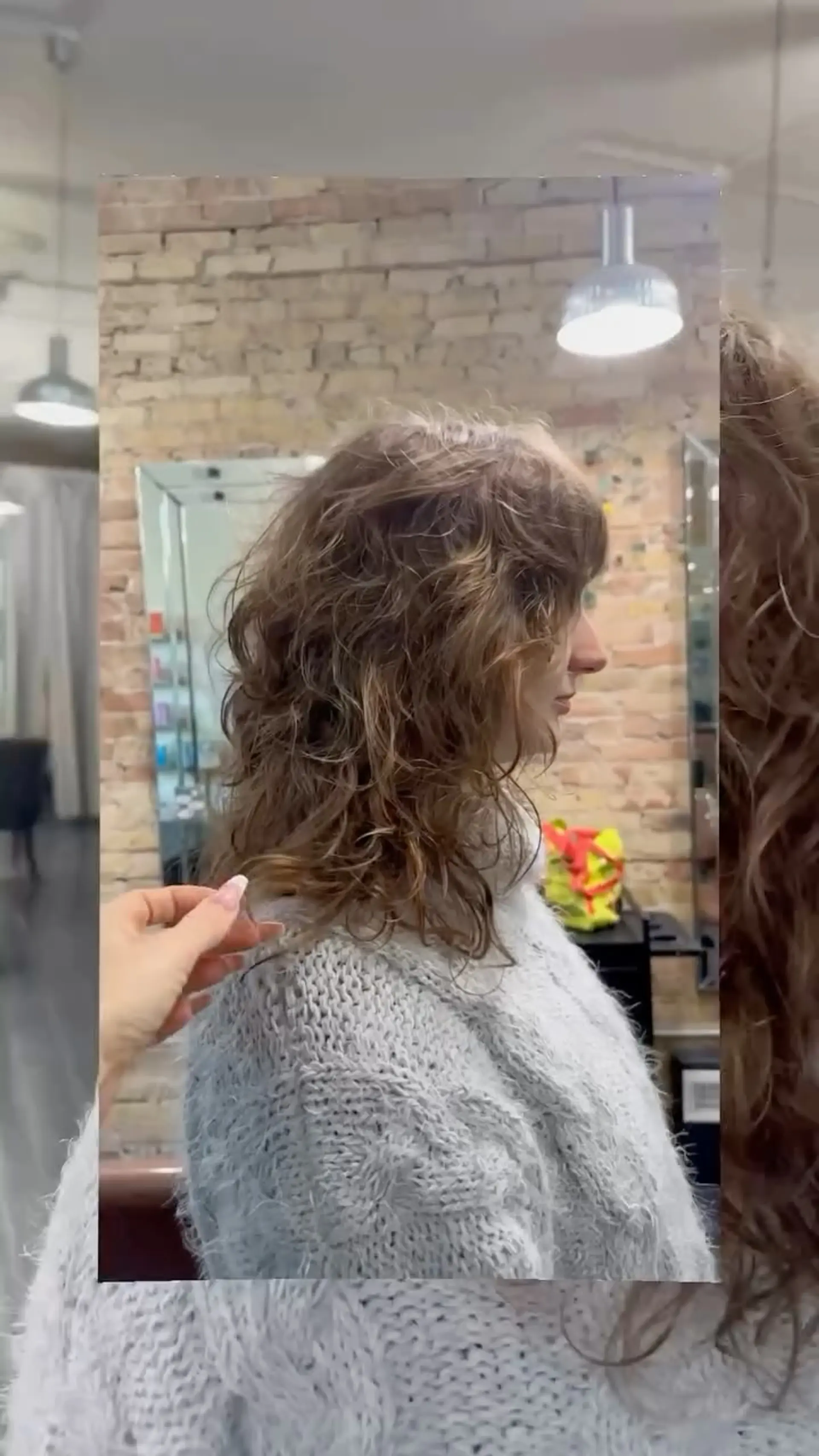 Medium-length shag haircut with heavy layers, soft fringe bangs, and tousled wavy texture. 1