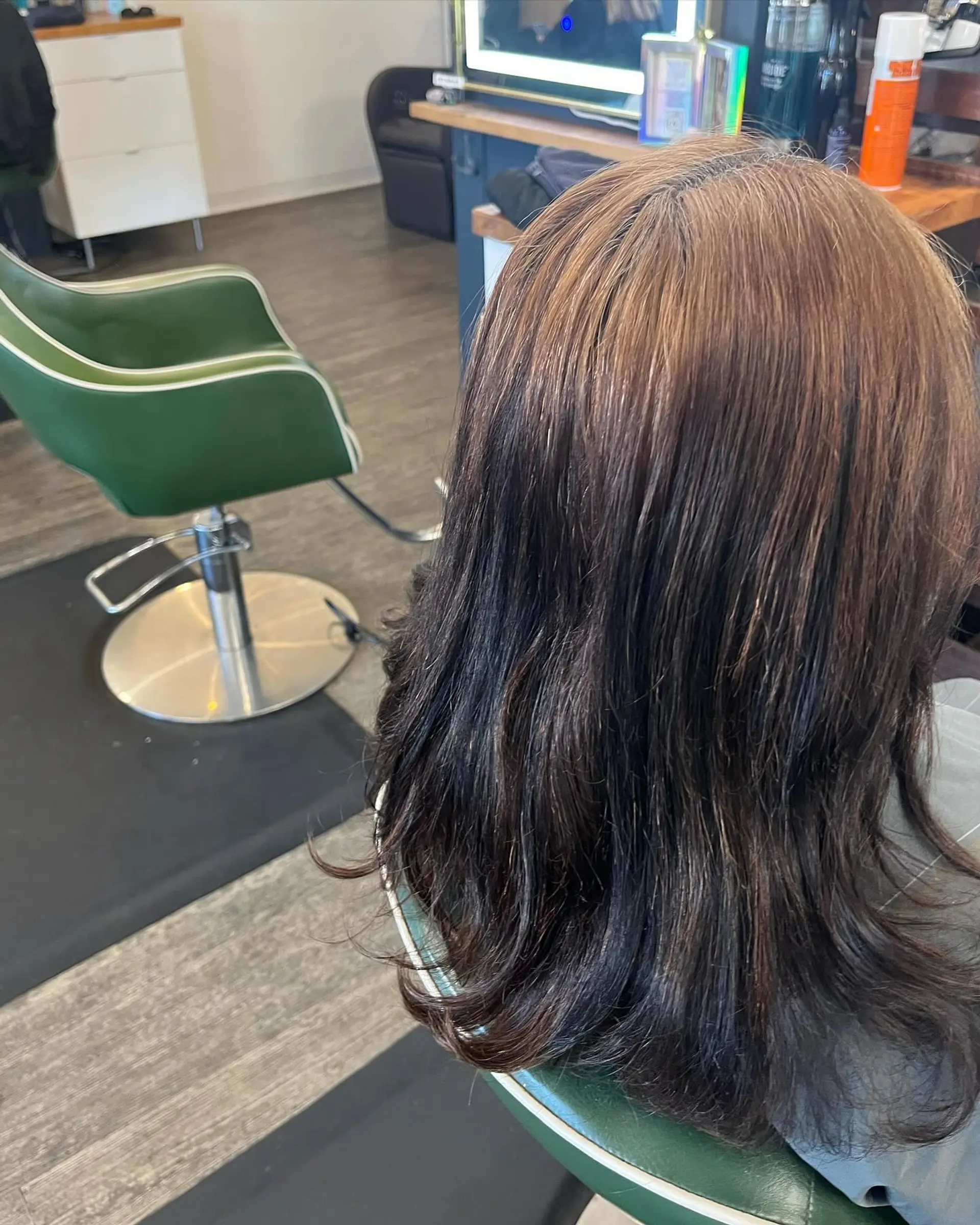 Medium-length brunette hair featuring a multi-tonal transition from warm brown roots to dark chocolate ends with soft layered texture. 1