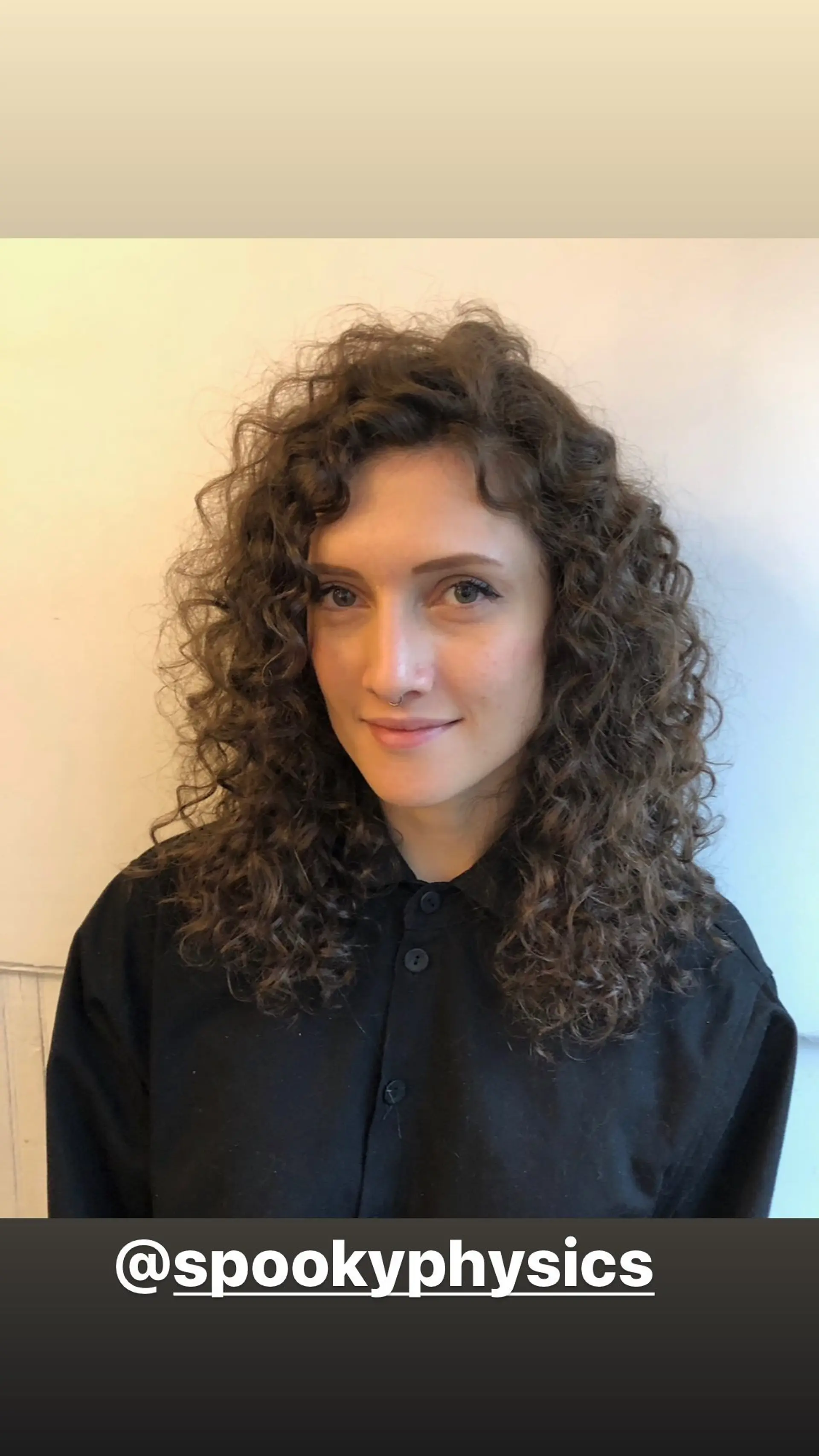 A medium-length hairstyle with natural, defined curls. 1