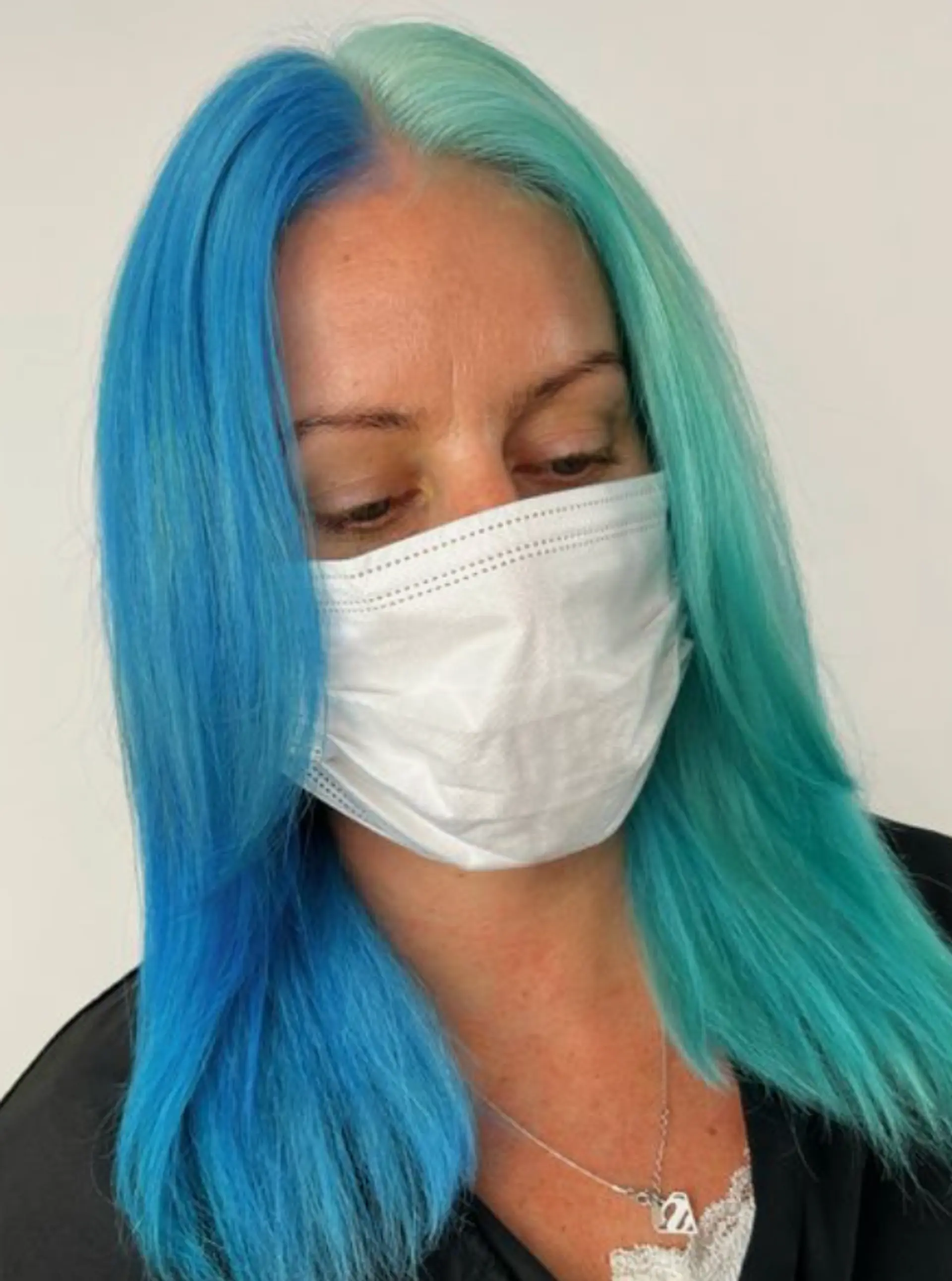 Long, straight hair with a dual-tone color effect, turquoise on the left and deep blue on the right, creating a vibrant and sleek look. 2