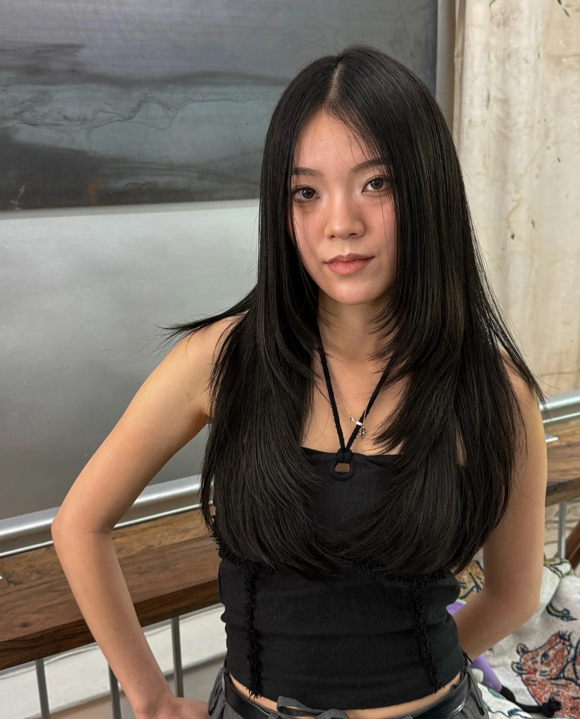 A long layered haircut with face-framing layers in a butterfly style. 1