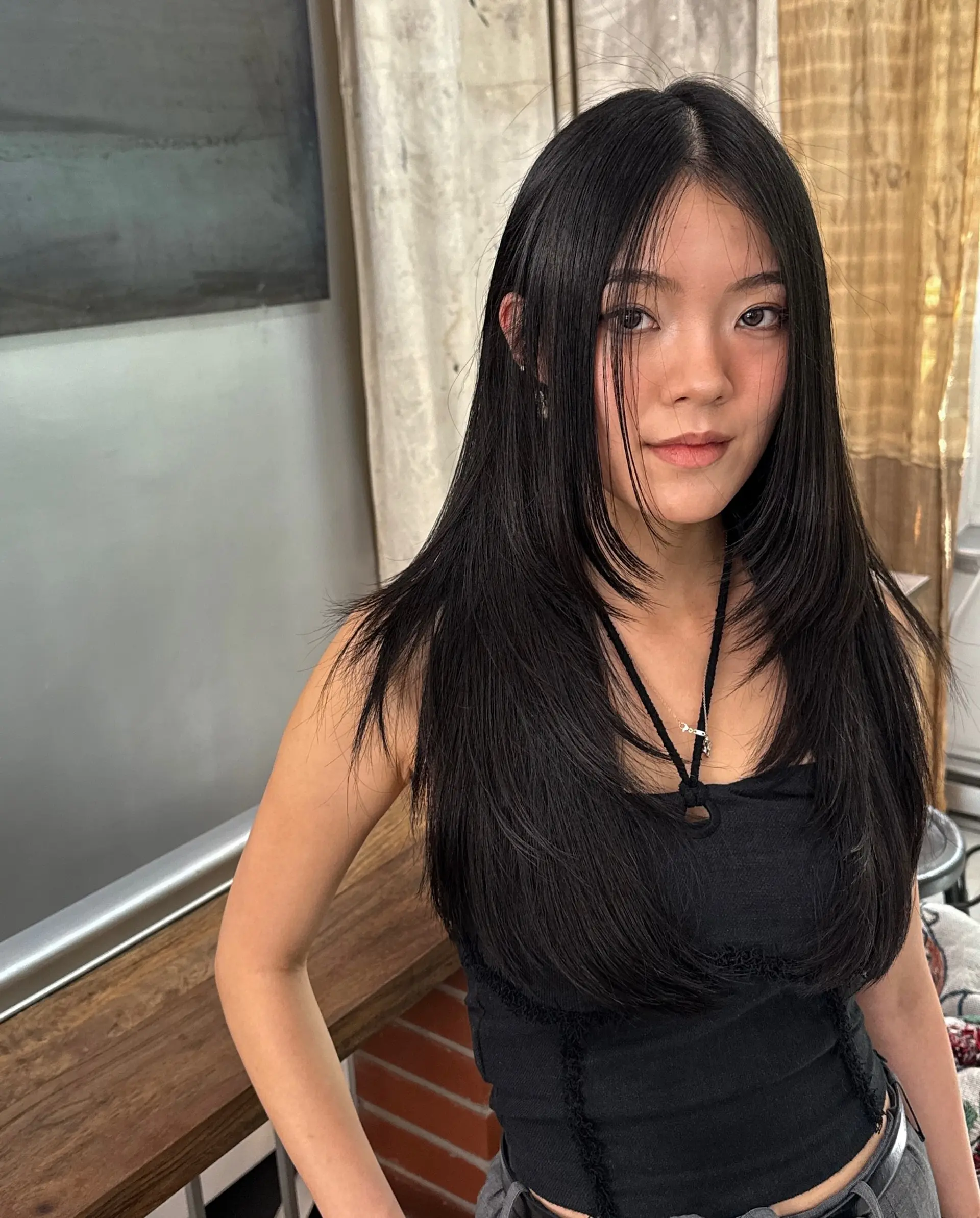 A long layered haircut with face-framing layers in a butterfly style. 2