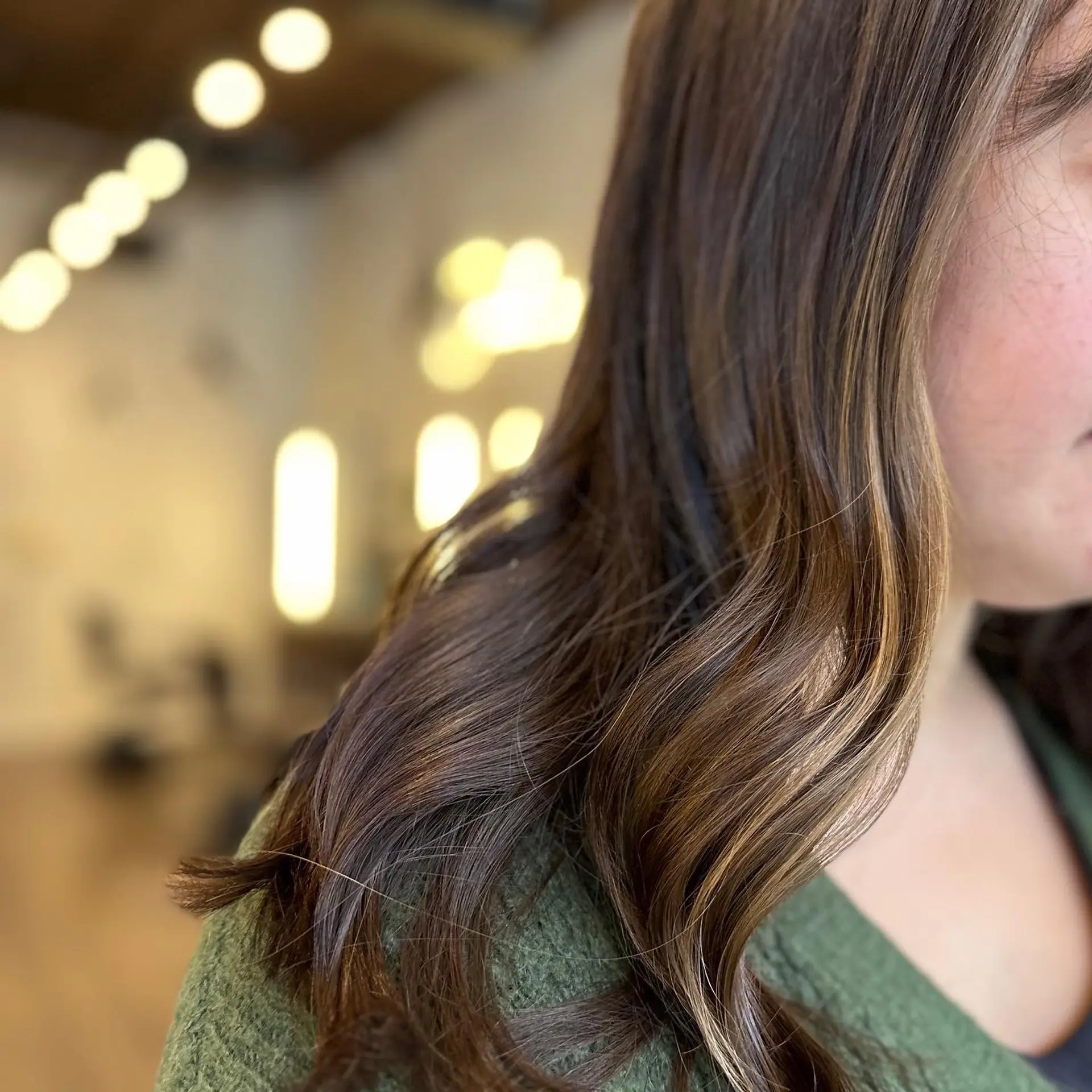 A medium length bronde wavy balayage style. 1