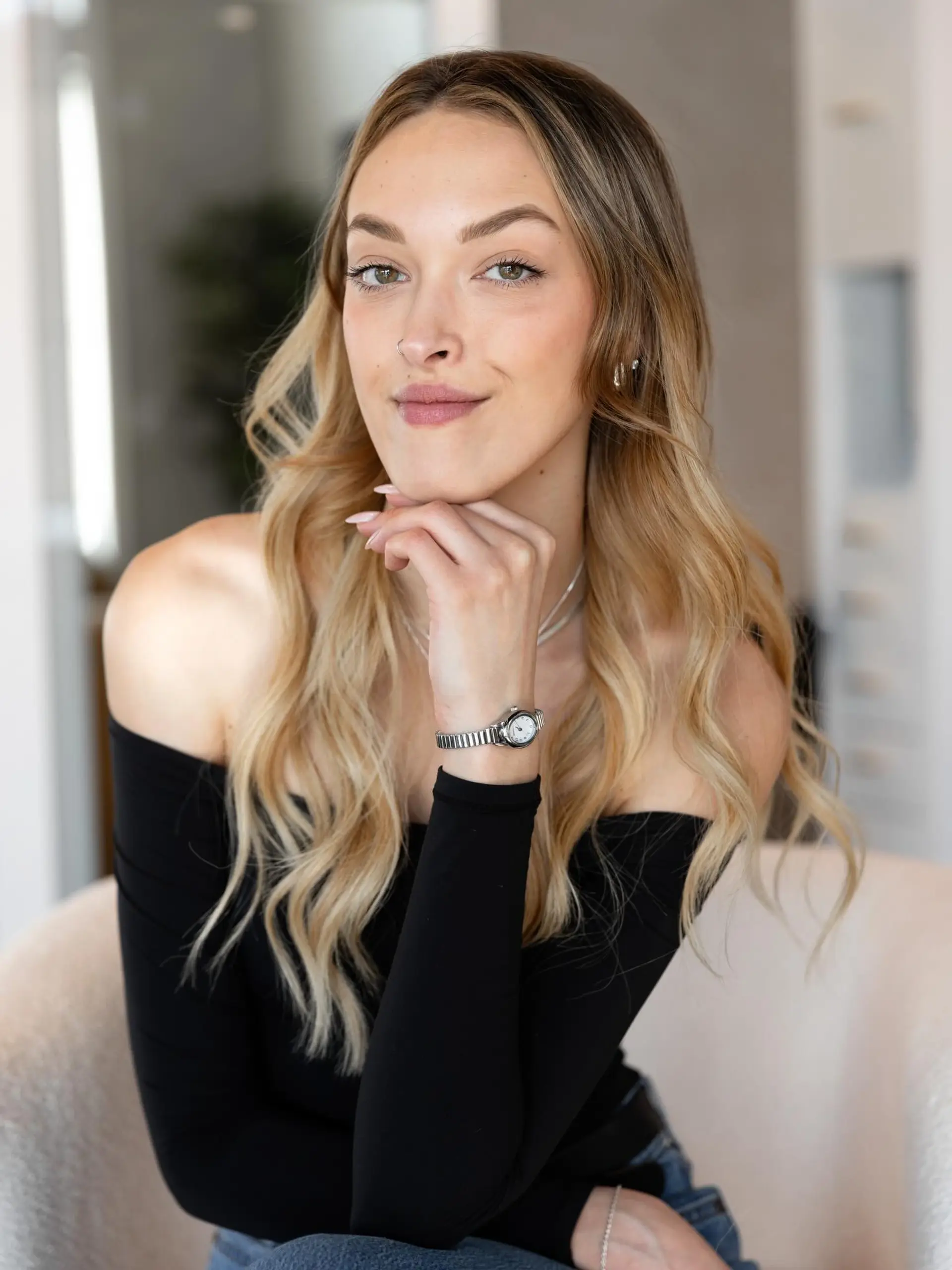 Long dimensional blonde hair styled in soft, loose waves parted down the middle. 1