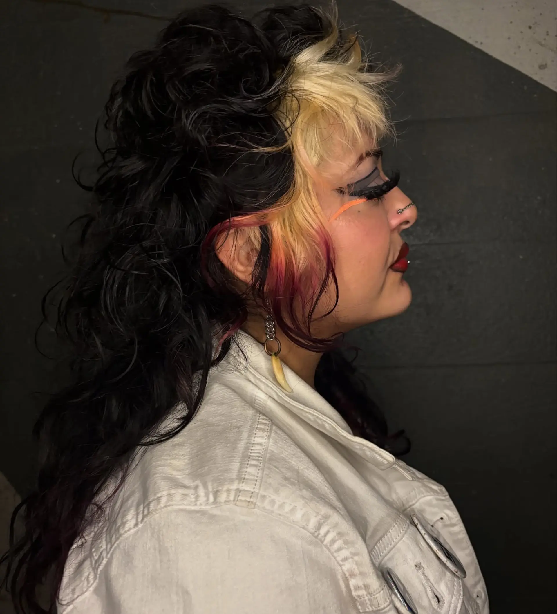 A textured curly mullet featuring contrast blonde face-framing panels and fringe finished with raspberry pink dipped tips. 1