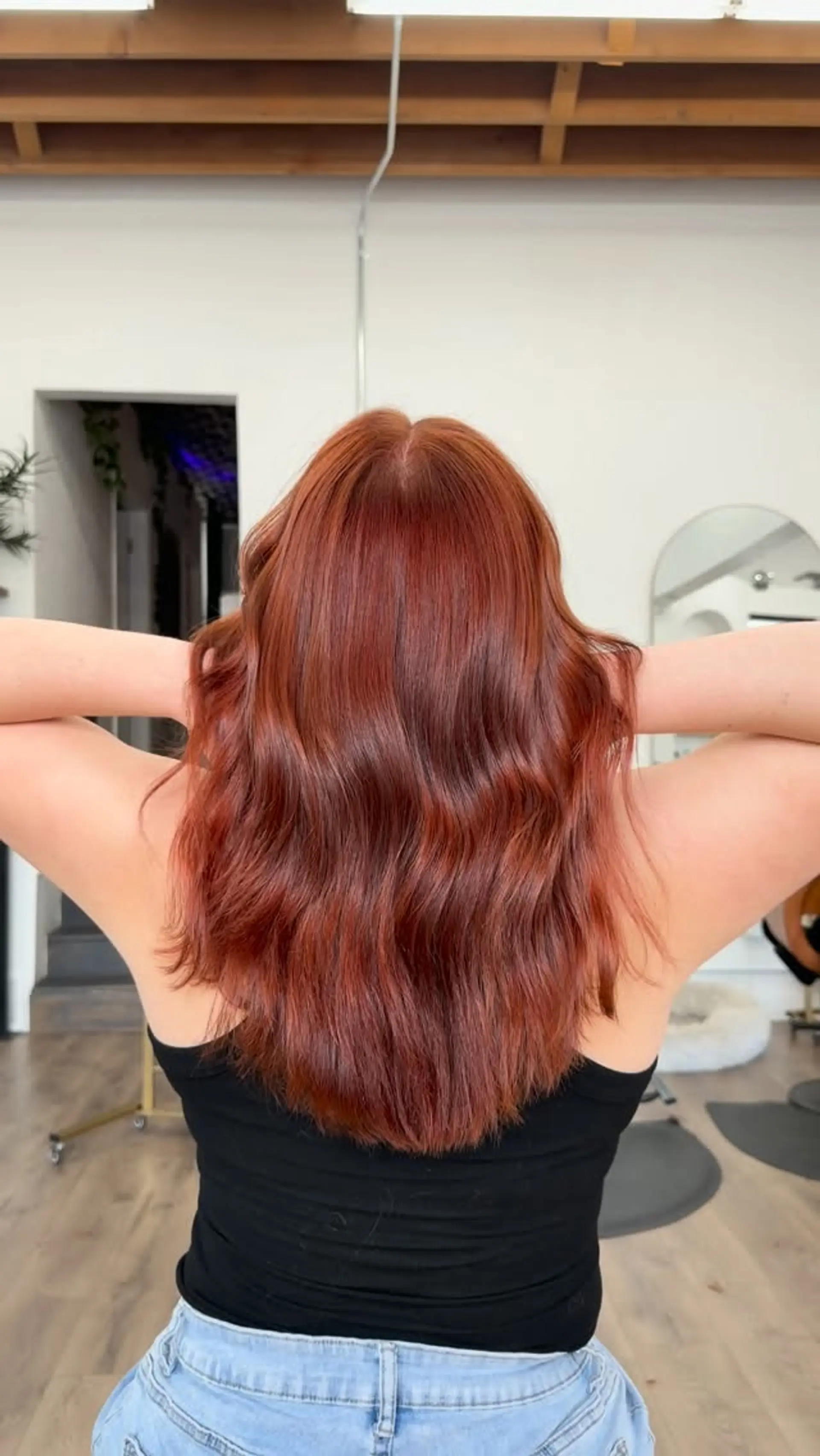 Vibrant cherry red long hair styled into smooth, soft flowing waves with a luminous shine. 1