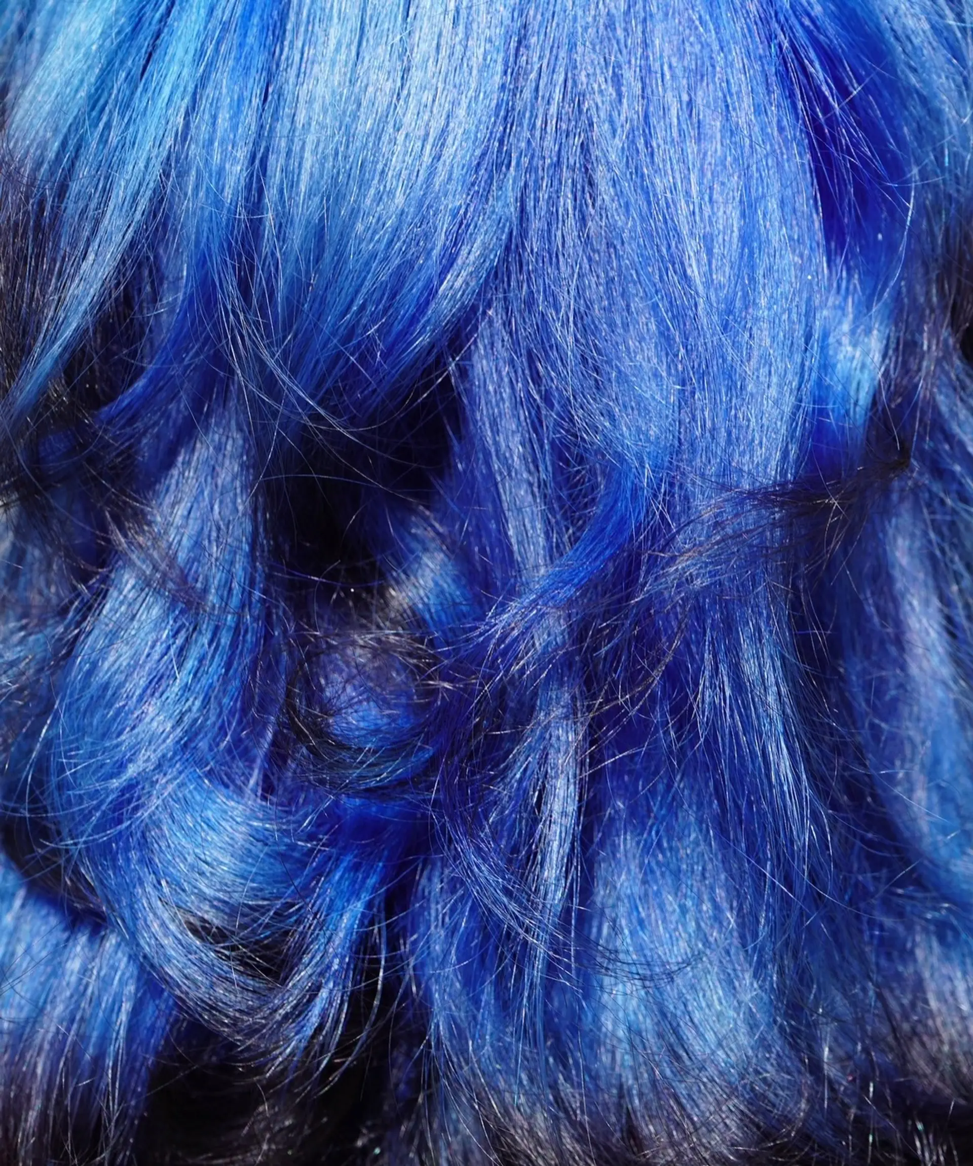 Vibrant cobalt blue hair styled in soft, textured waves. 1