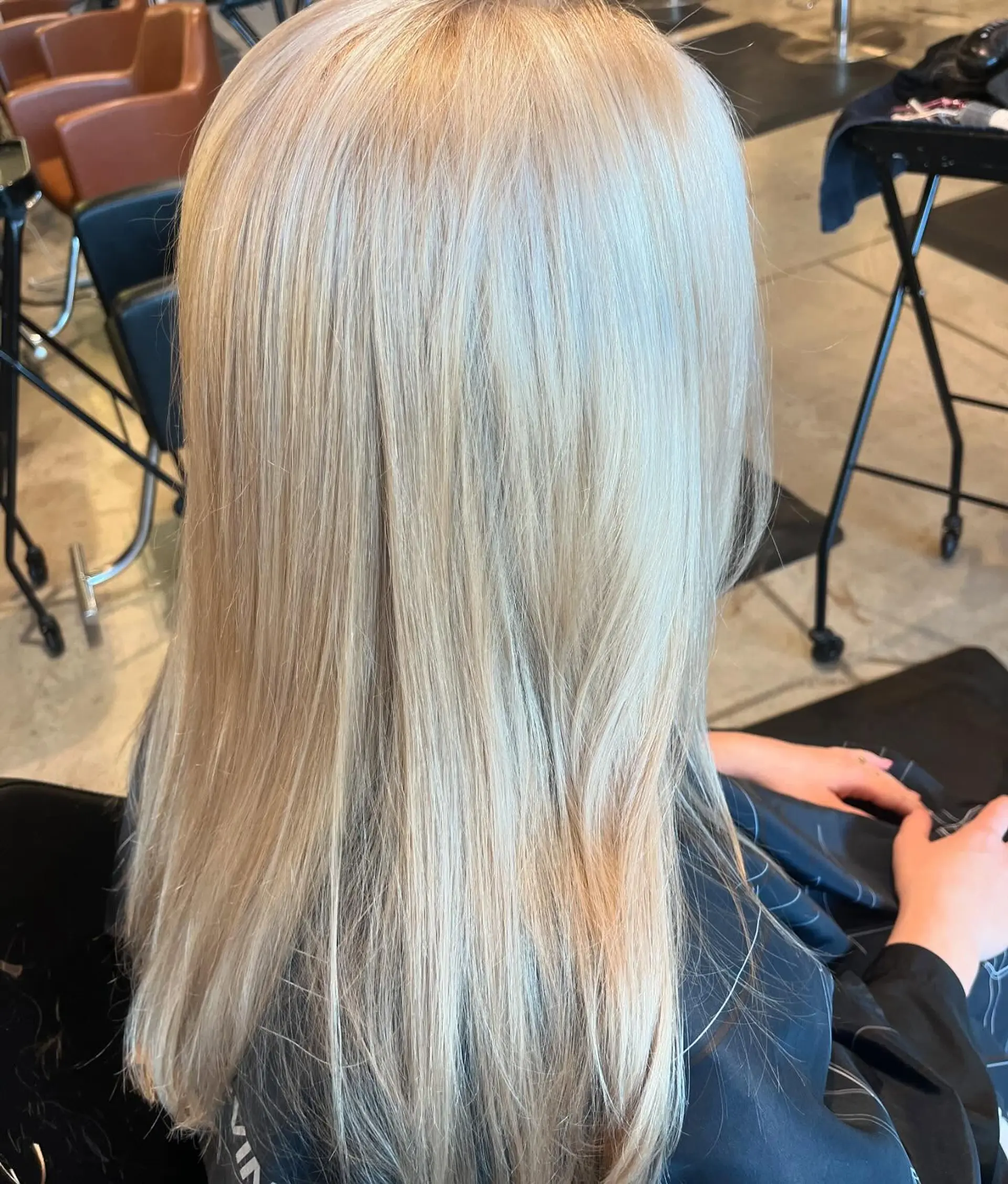 Long, sleek straight hair colored in an all-over pale platinum blonde. 1