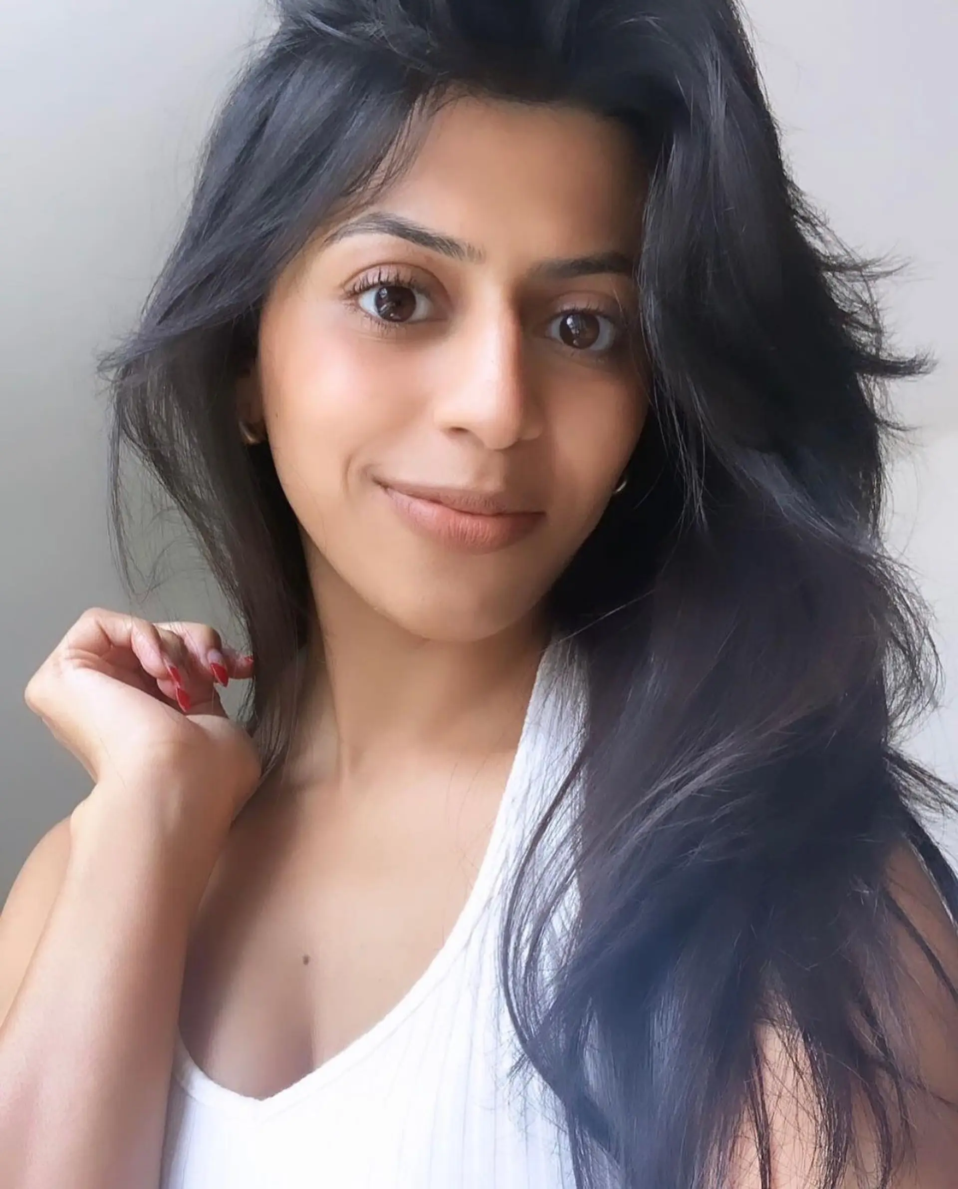 Long dark hair with textured, face-framing layers and soft natural volume. 1