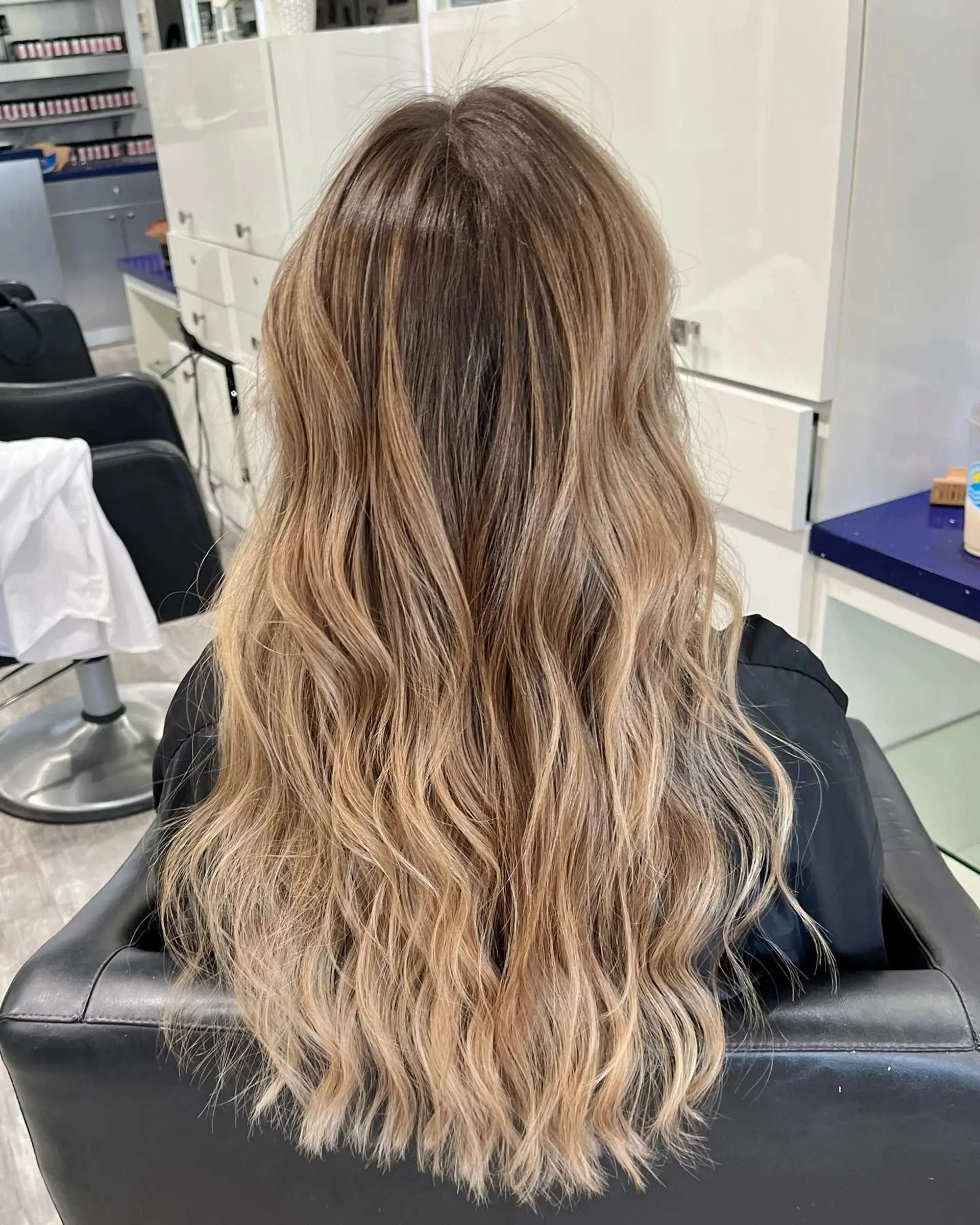 Long, flowing waves with a seamless balayage color melt. 1