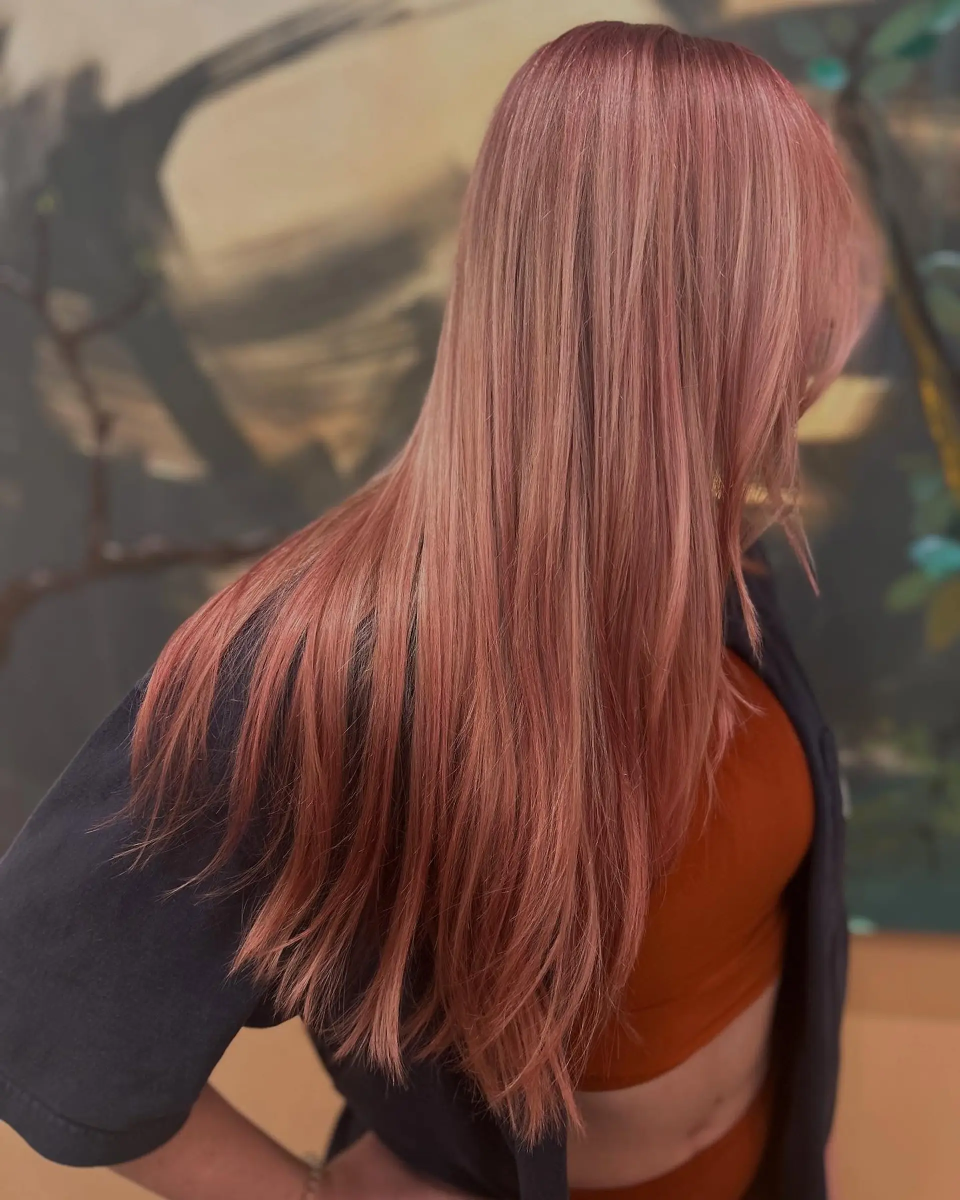 Long, sleek straight hair finished in a dimensional pastel rose gold pink tone. 1