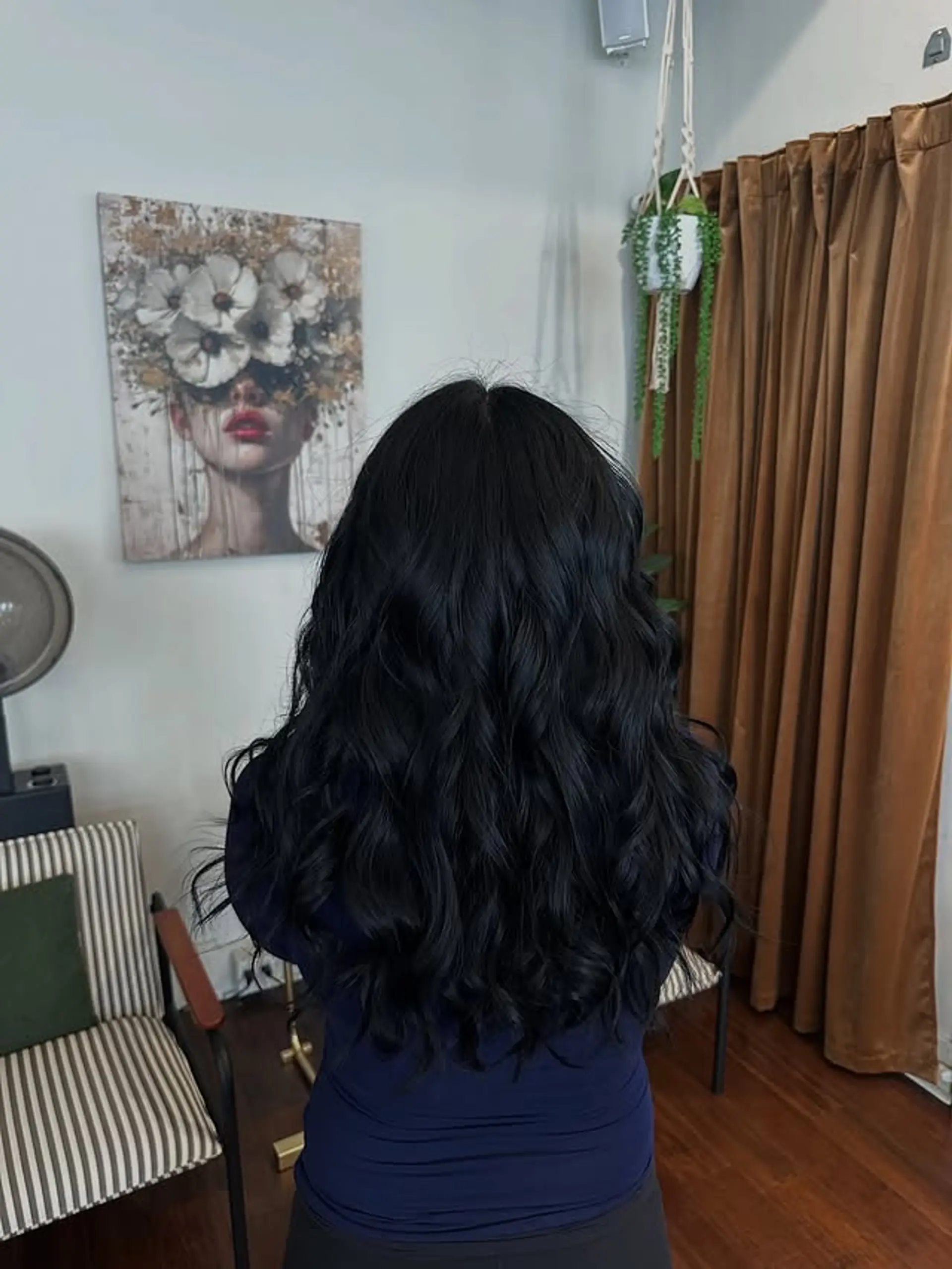 Long, layered, wavy hairstyle with a center part. 1