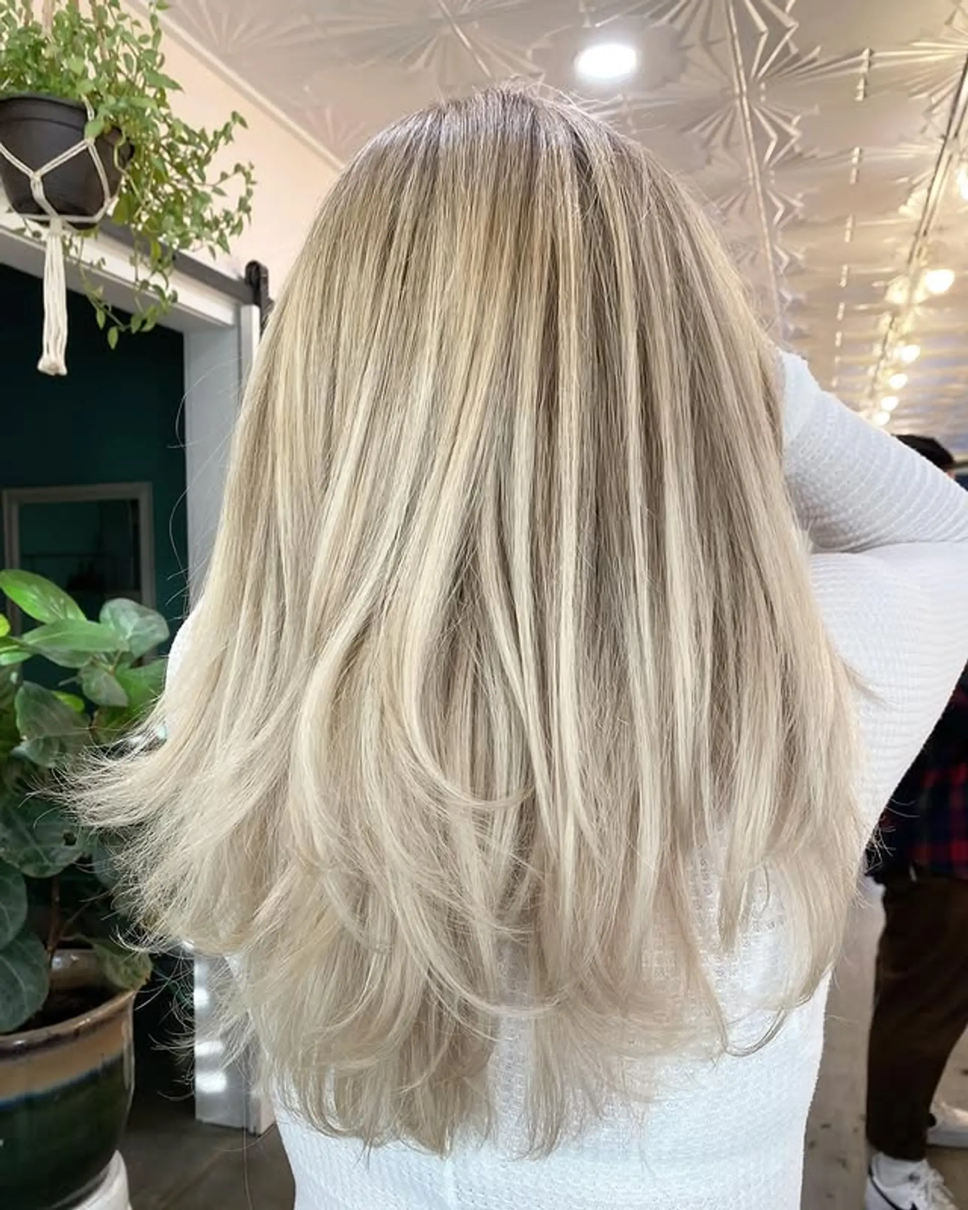 Long, layered wavy hairstyle with ash blonde and icy blonde balayage. 1