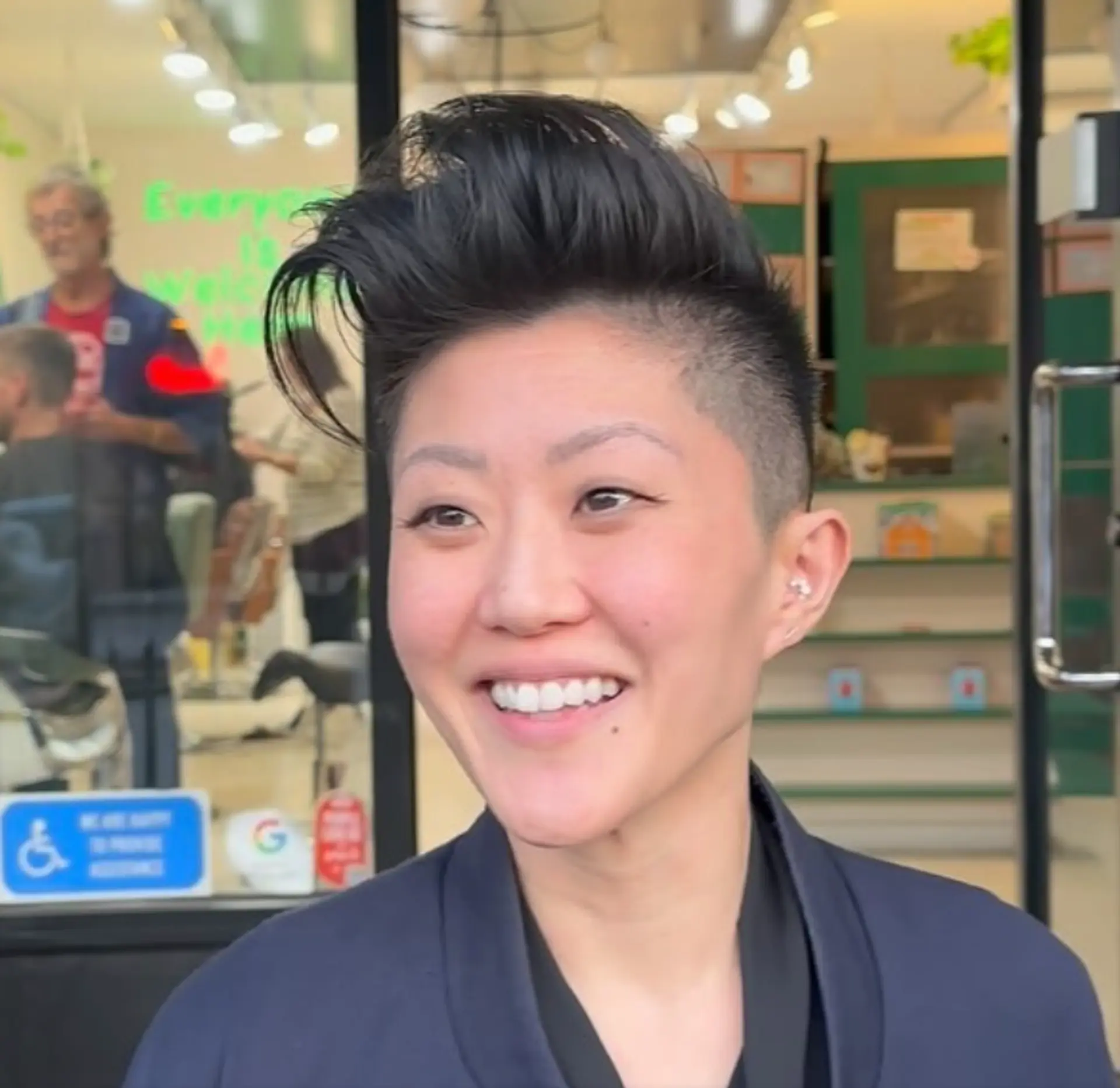 An edgy, asymmetrical undercut with short buzzed sides and a textured, voluminous top styled upwards. 1