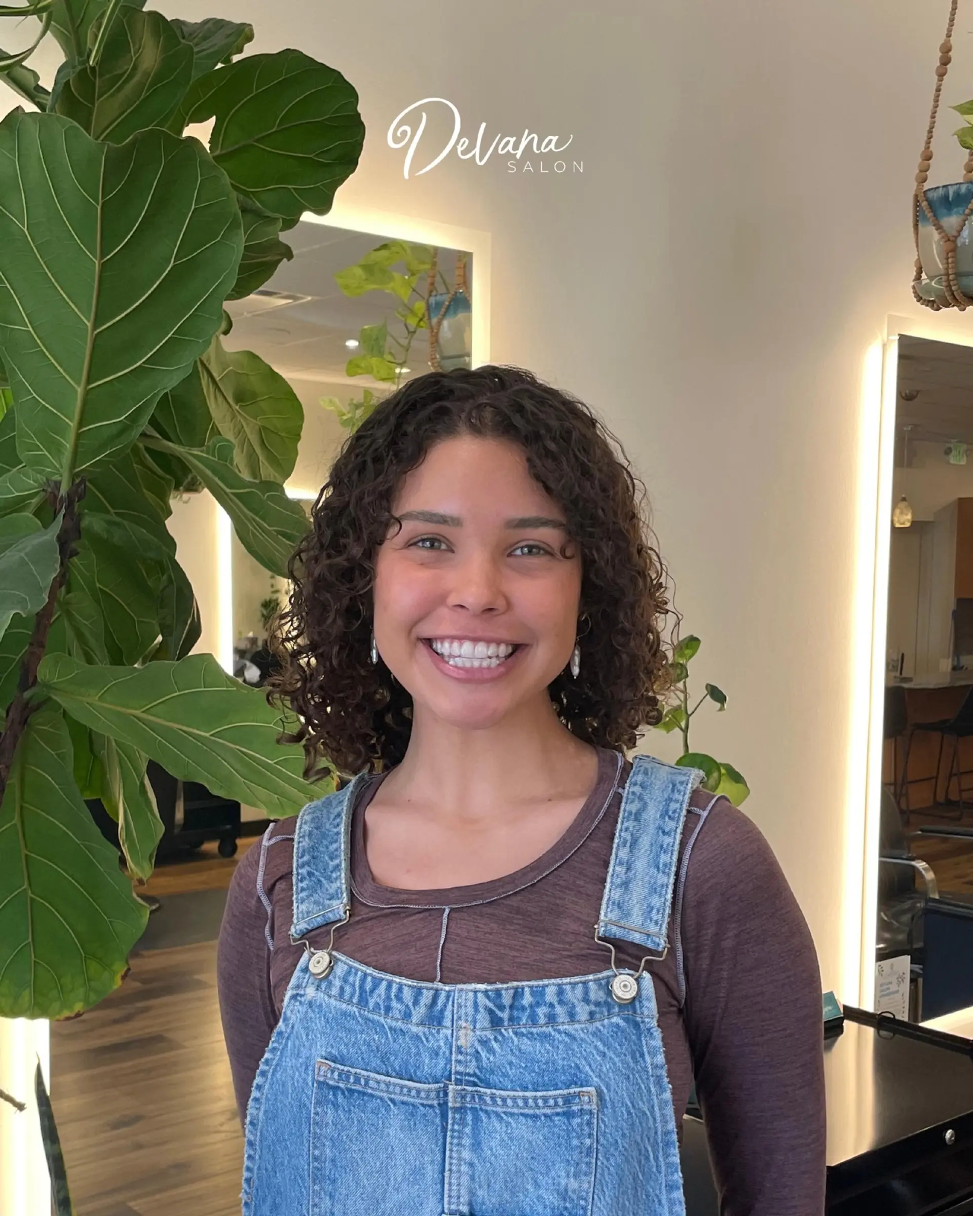 Shoulder-length dark brown curly hair styled with defined, bouncy curls and natural volume. 1