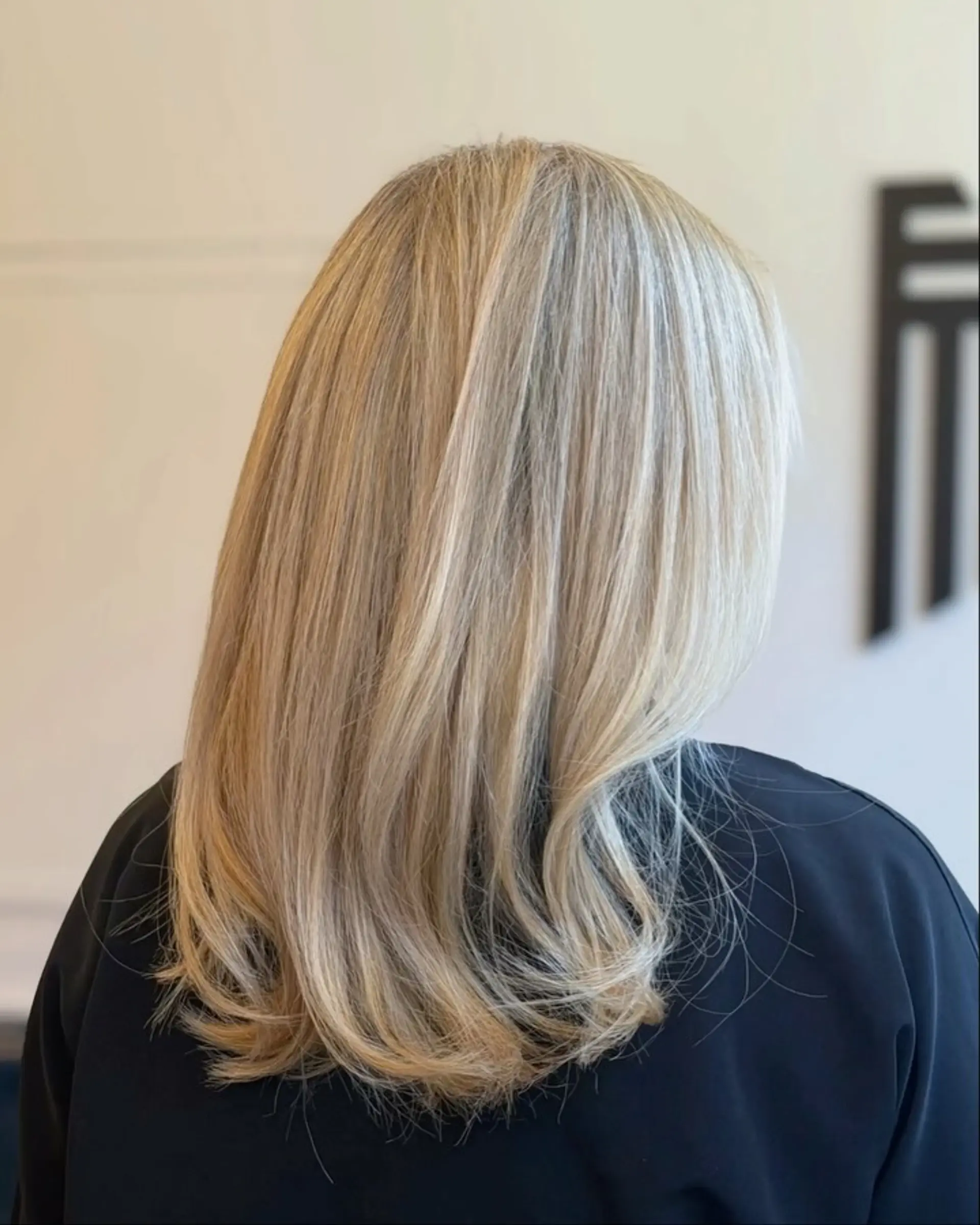 Long, smooth straight blonde hair with softly curved ends and multi-tonal dimensional highlights. 1