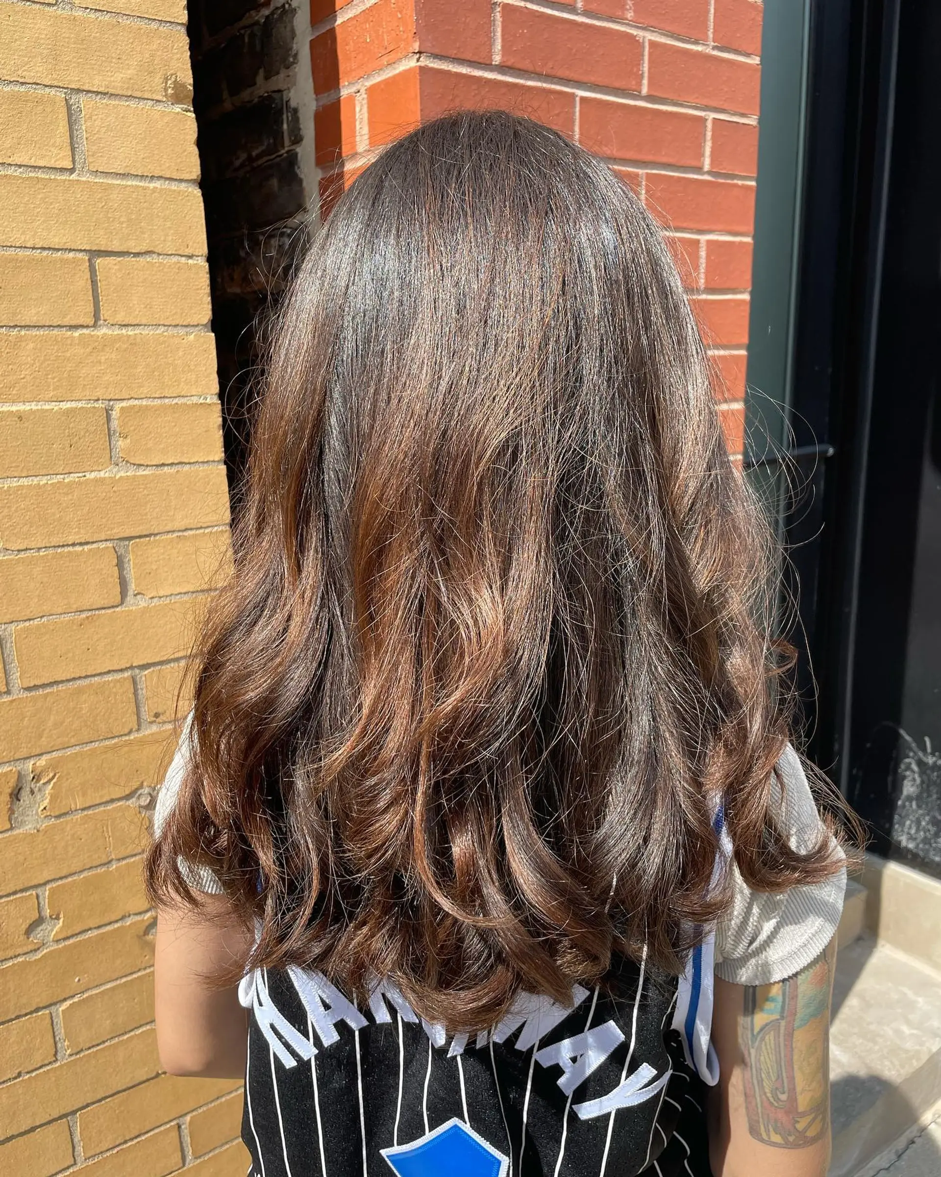 Long layered wavy hair with auburn balayage highlights. 1