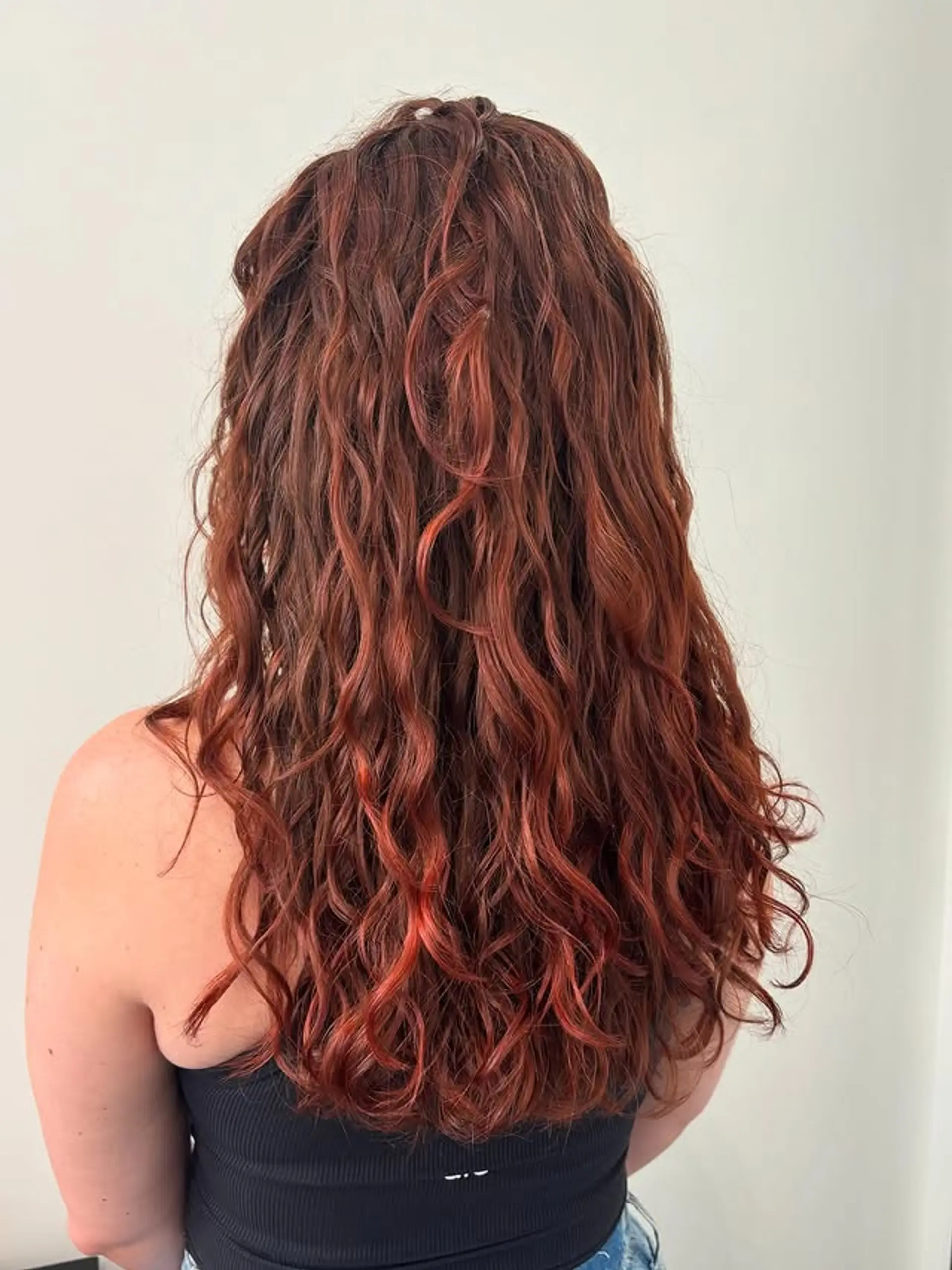 Long, curly hair with a copper and red balayage. 1