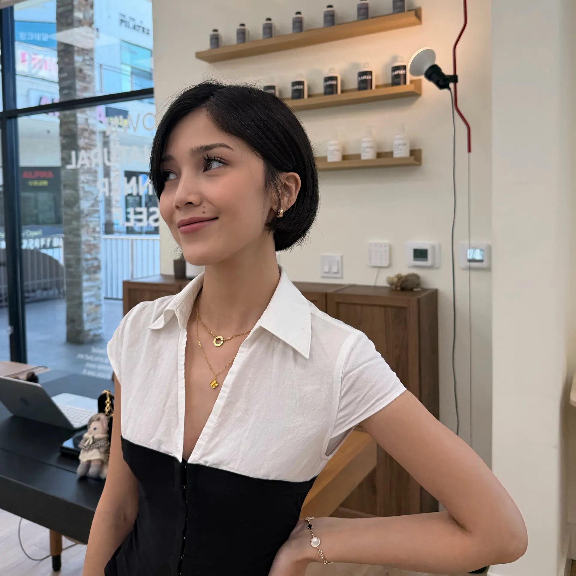 A sleek, side-parted short bob with softly tapered ends tucked neatly behind the ear. 1