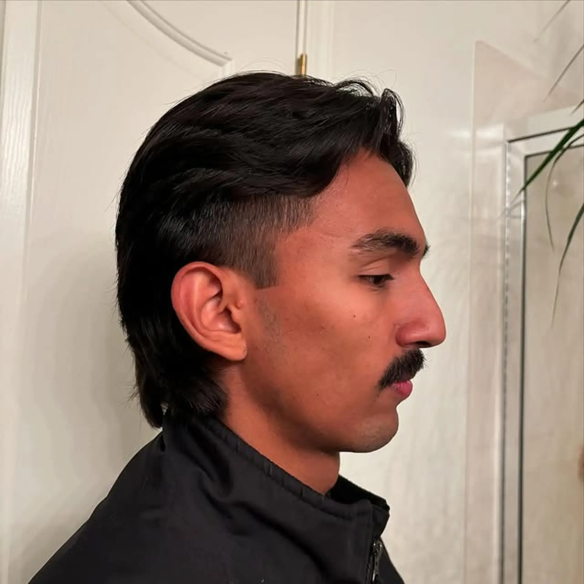 A modern mullet featuring a faded side cut and a textured top. 1