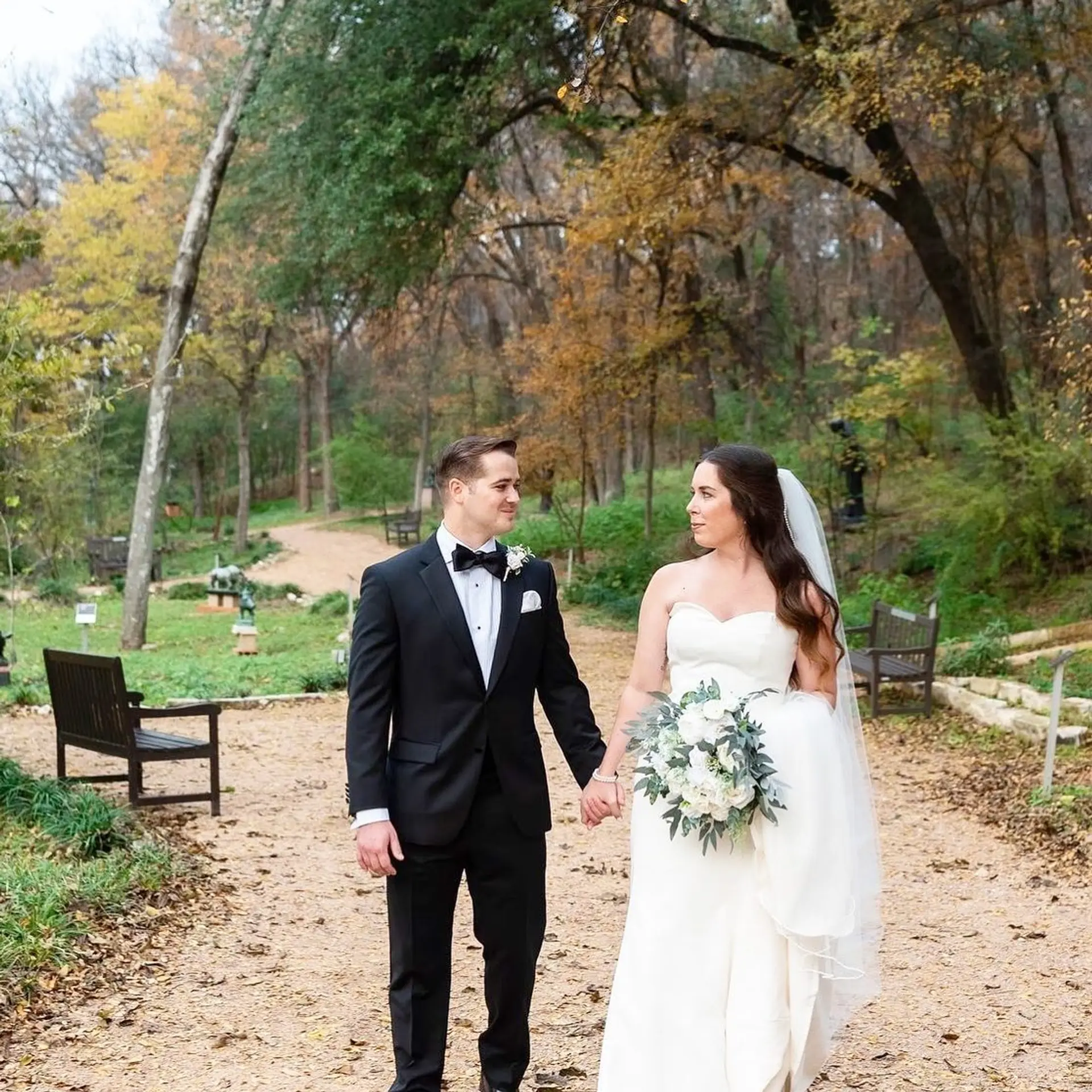 Romantic long dark brown waves styled down for a bride with an attached veil. 1