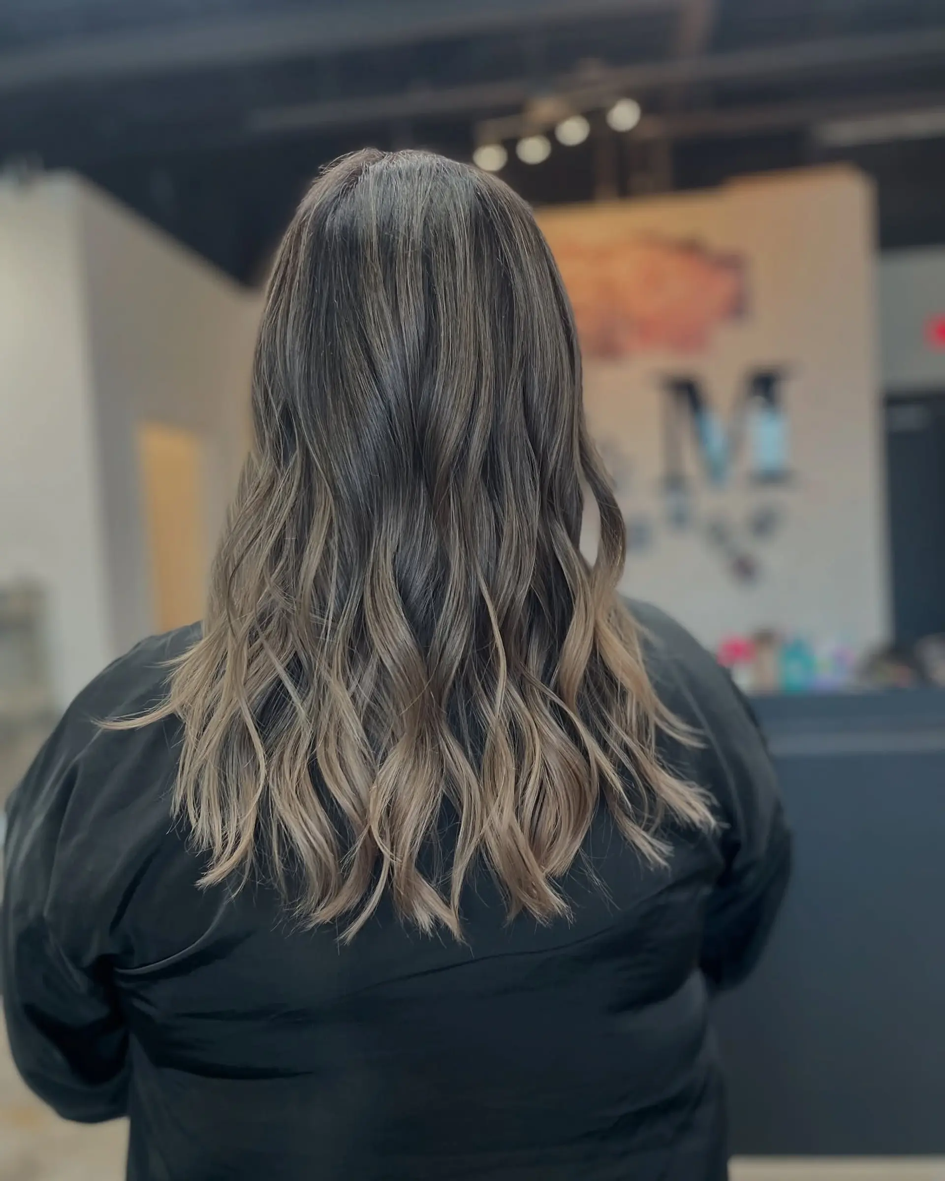 Long, wavy hair with an ombre bronde color, creating a soft and dimensional look. 1