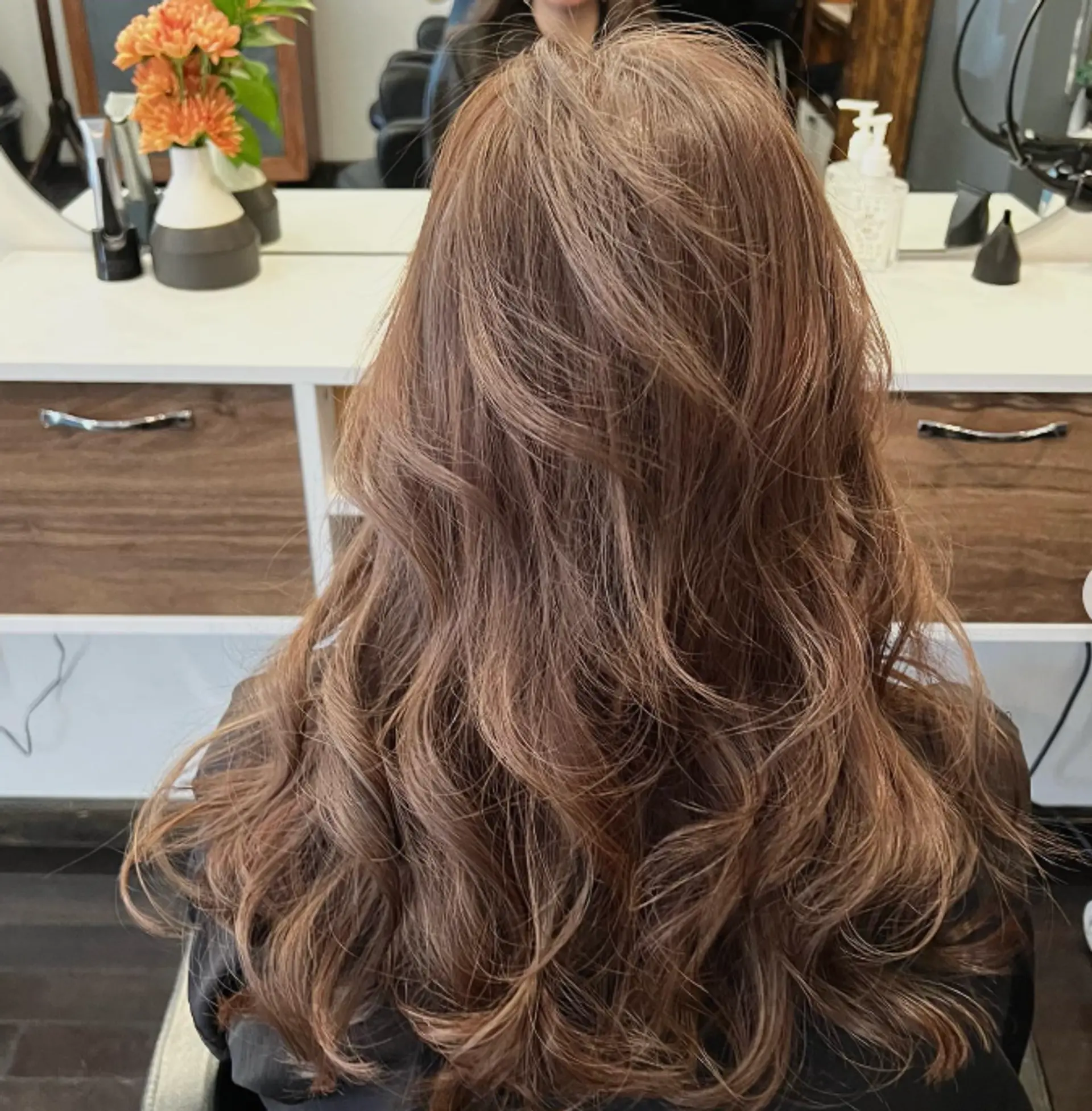 Long, layered, wavy bronzed hair with a balayage. 1