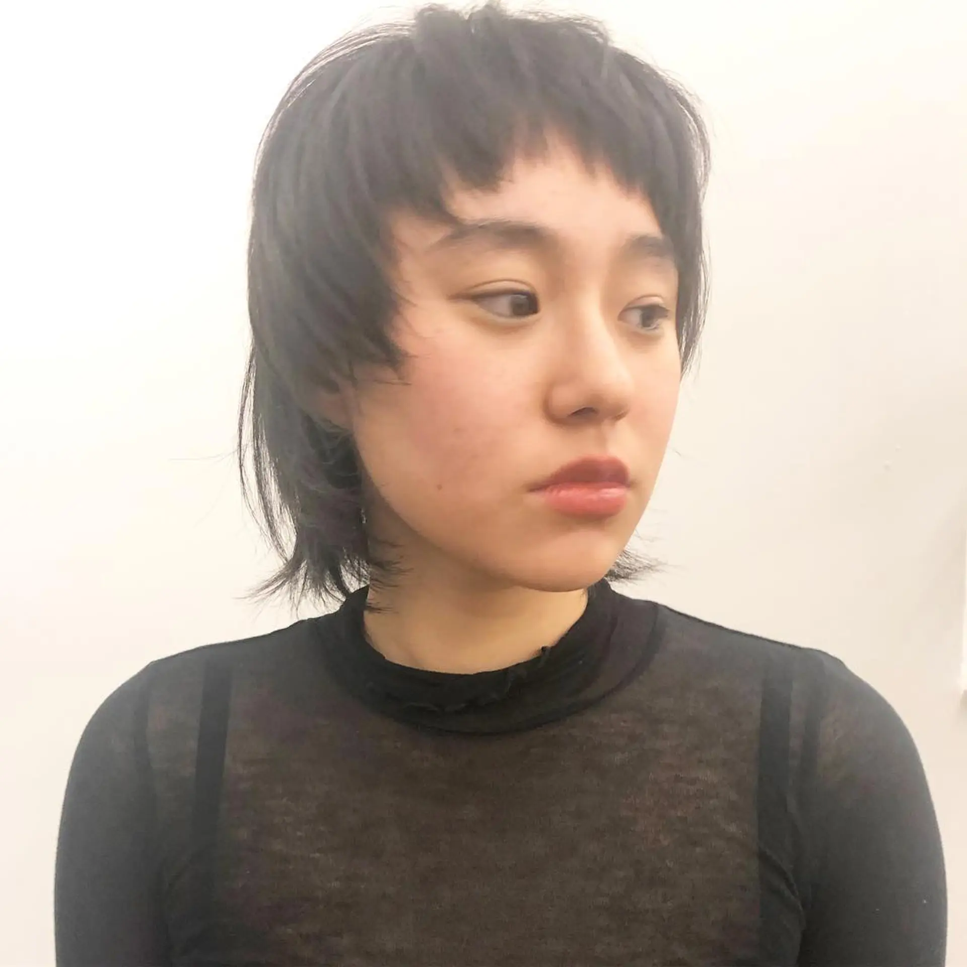 A  layered mullet cut with a bold, choppy fringe. The hair is straight and cut short with textured layers, giving it volume and movement by Takeo. 2