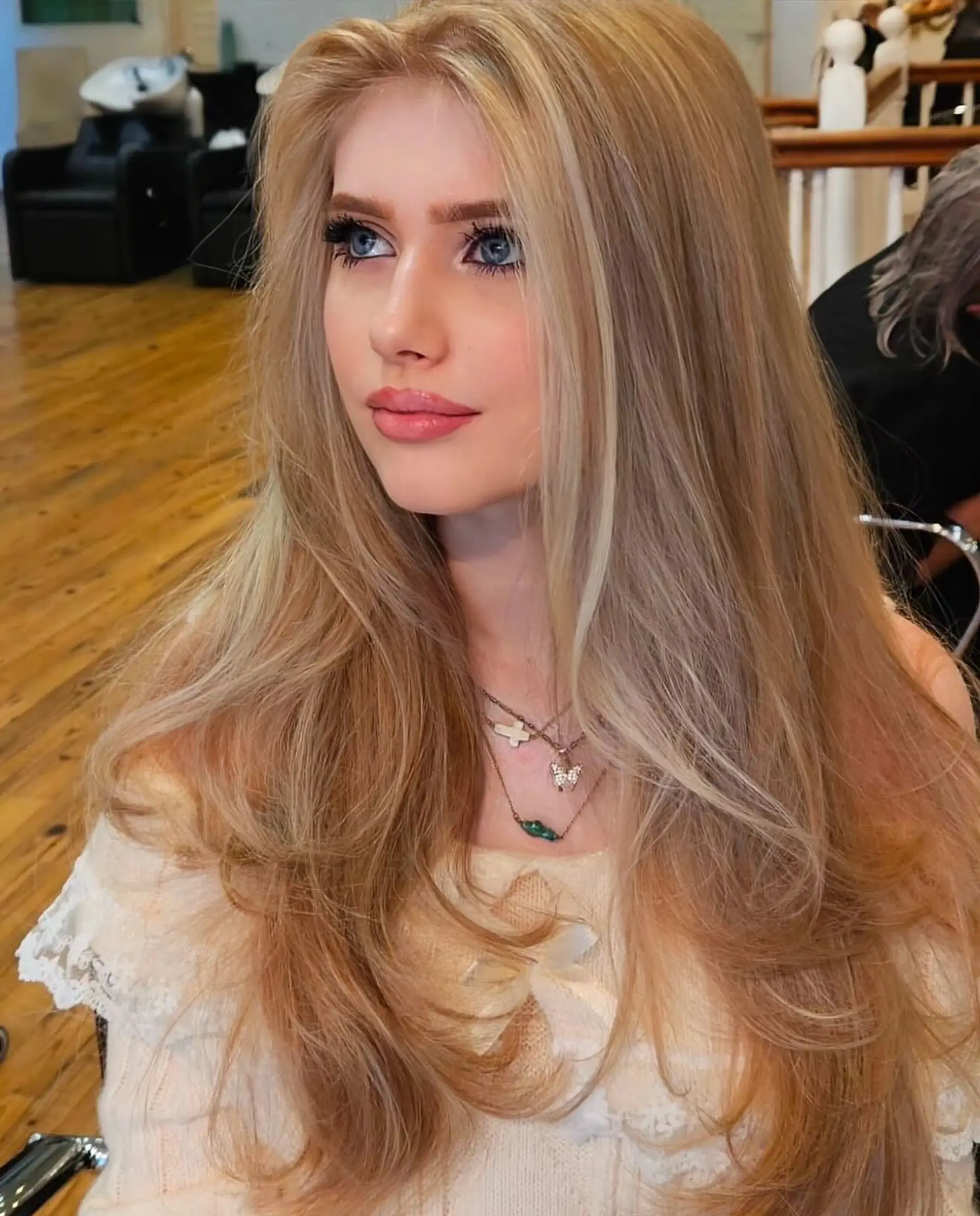 Long, straight hair with layers and a honey blonde balayage. 1