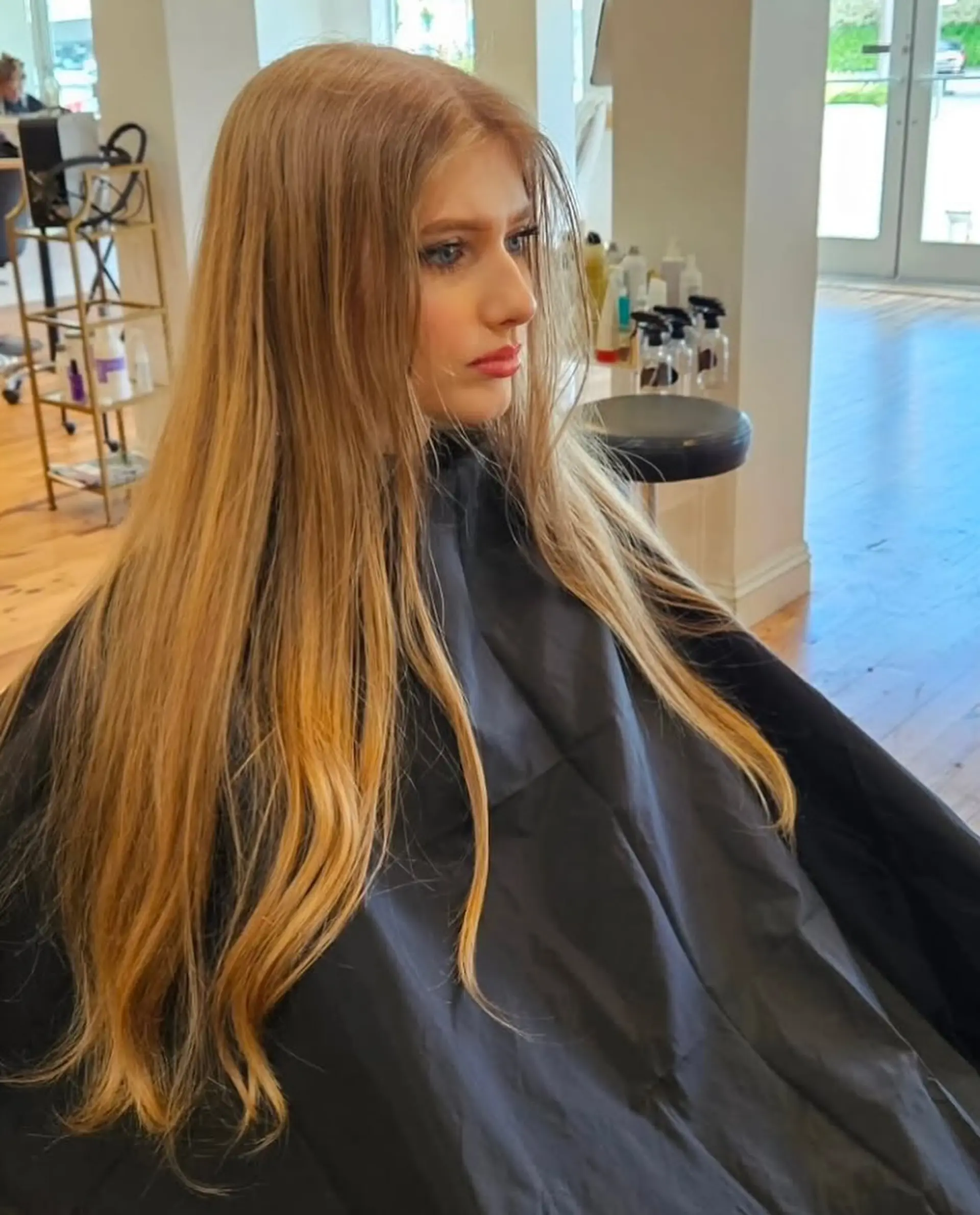Long, straight hair with layers and a honey blonde balayage. 3