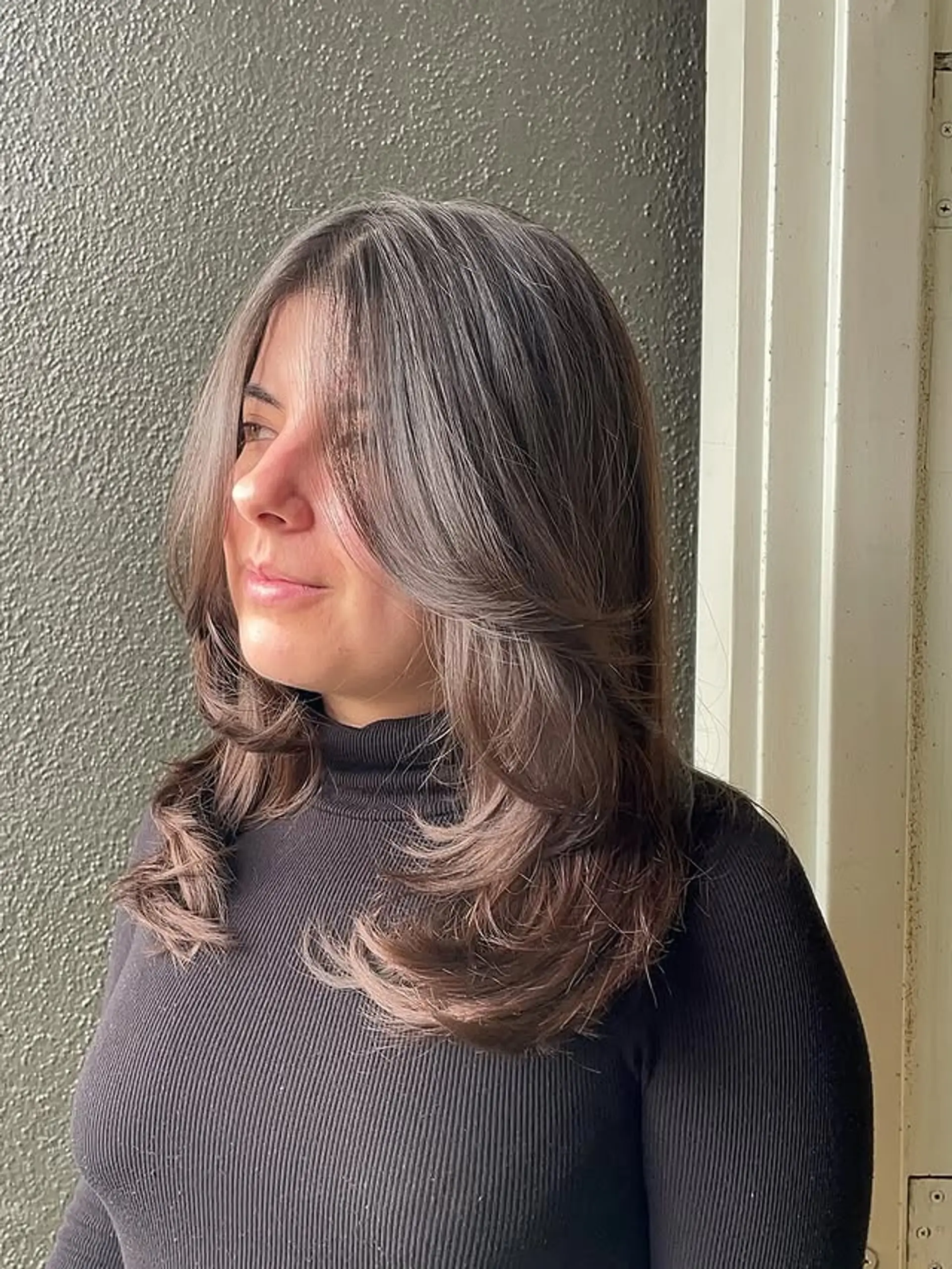 Long layered haircut with face-framing layers and subtle balayage highlights. 1