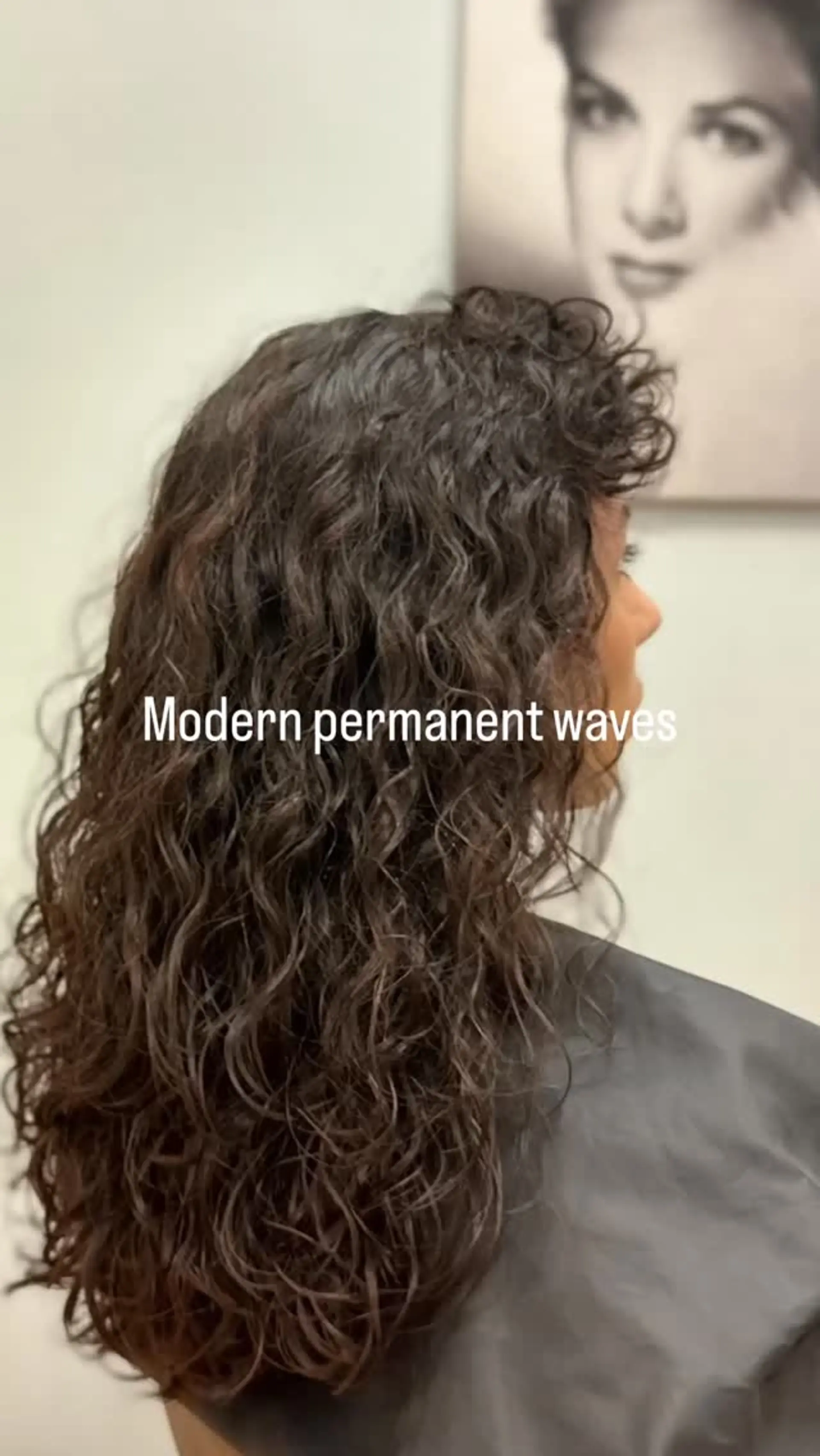 Long brunette hair featuring defined, textured modern permanent waves with curly bangs. 1
