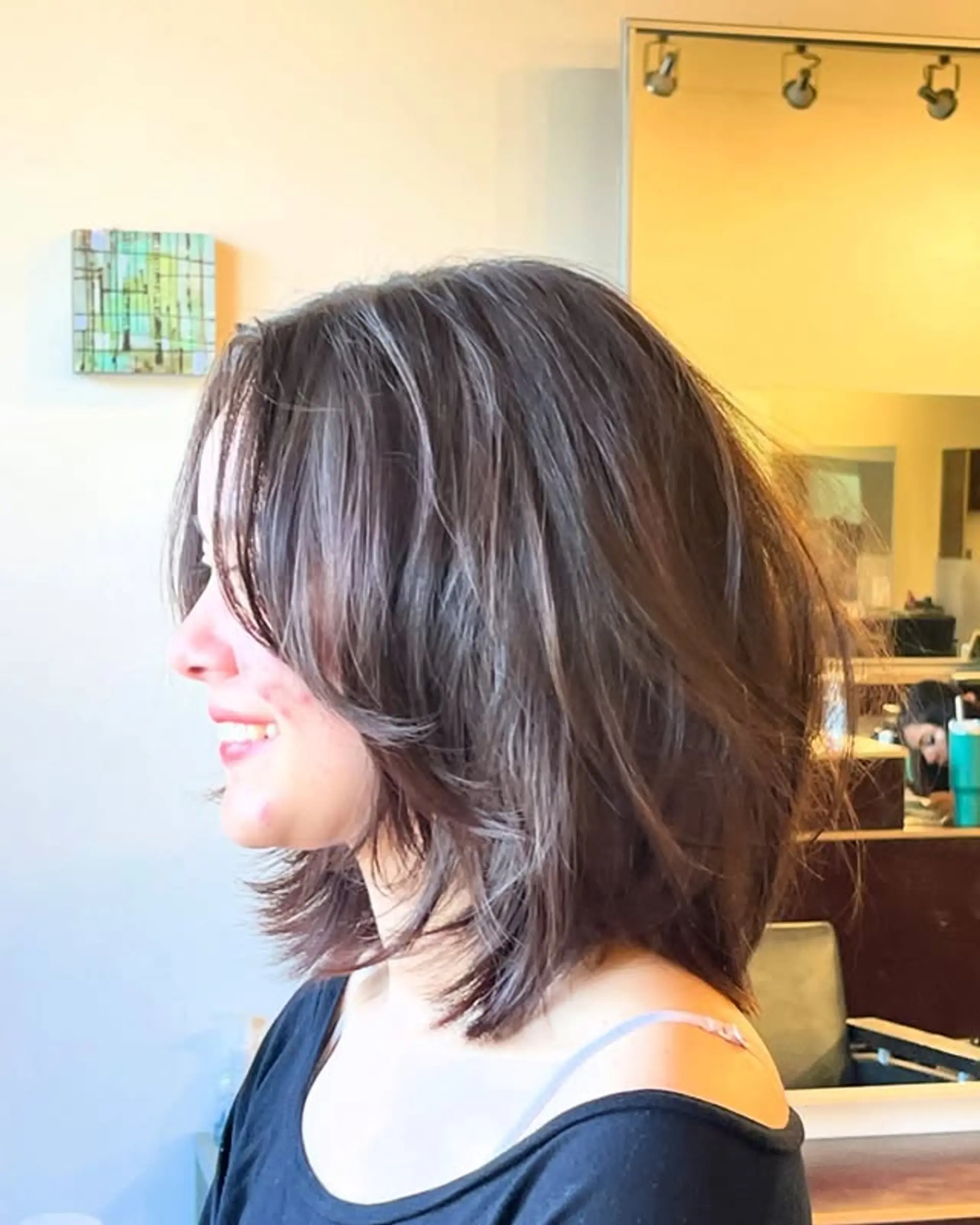 A medium-length shag haircut with choppy layers and face-framing curtain bangs. 1