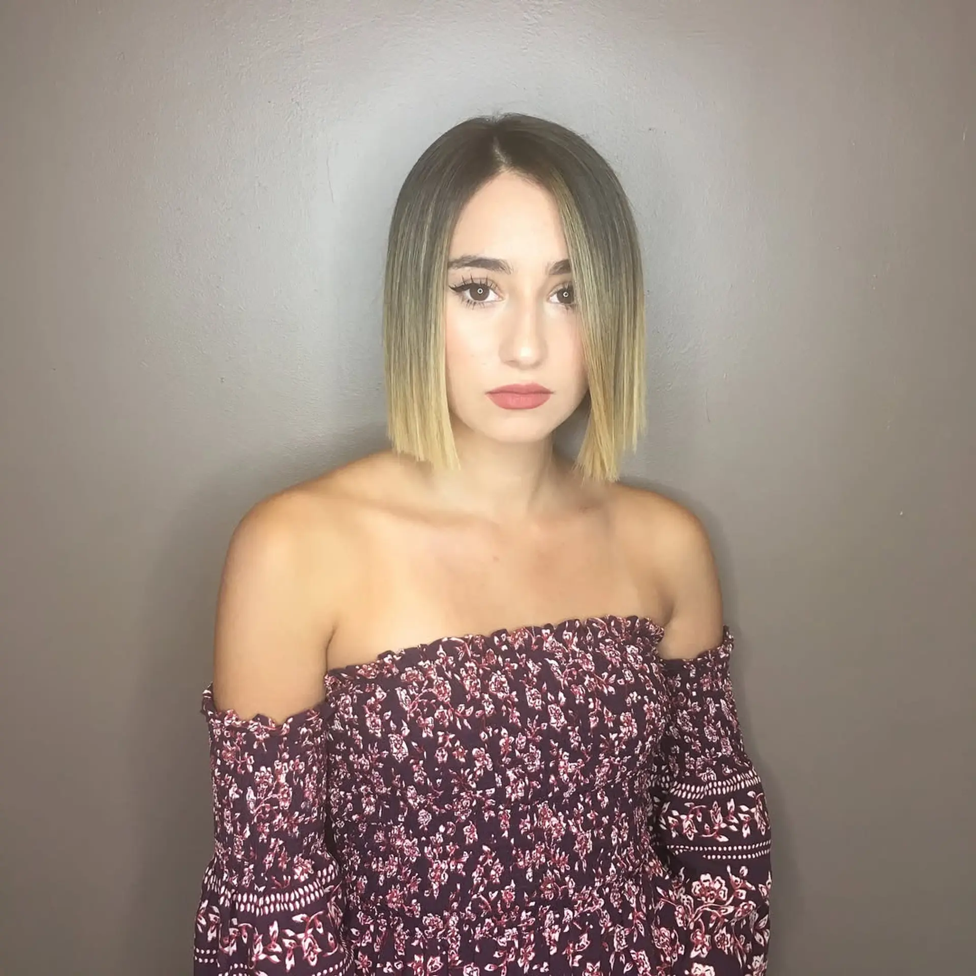 A sharp chin-length blunt bob styled straight with a smooth dark-to-blonde balayage gradient. 1