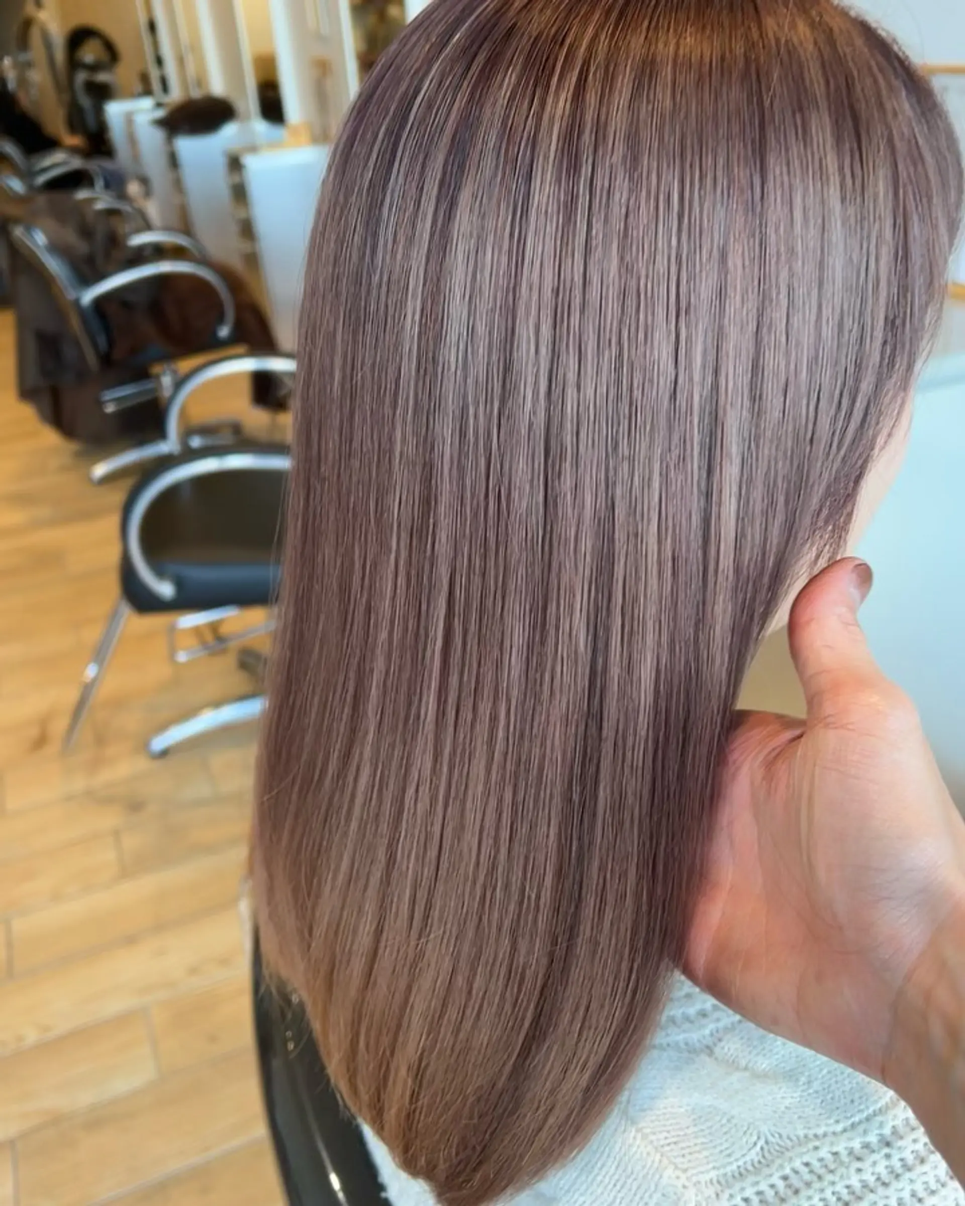 A sleek, shoulder-length straight hairstyle dyed in a smooth, cool-toned milk tea ash color with high gloss. 1