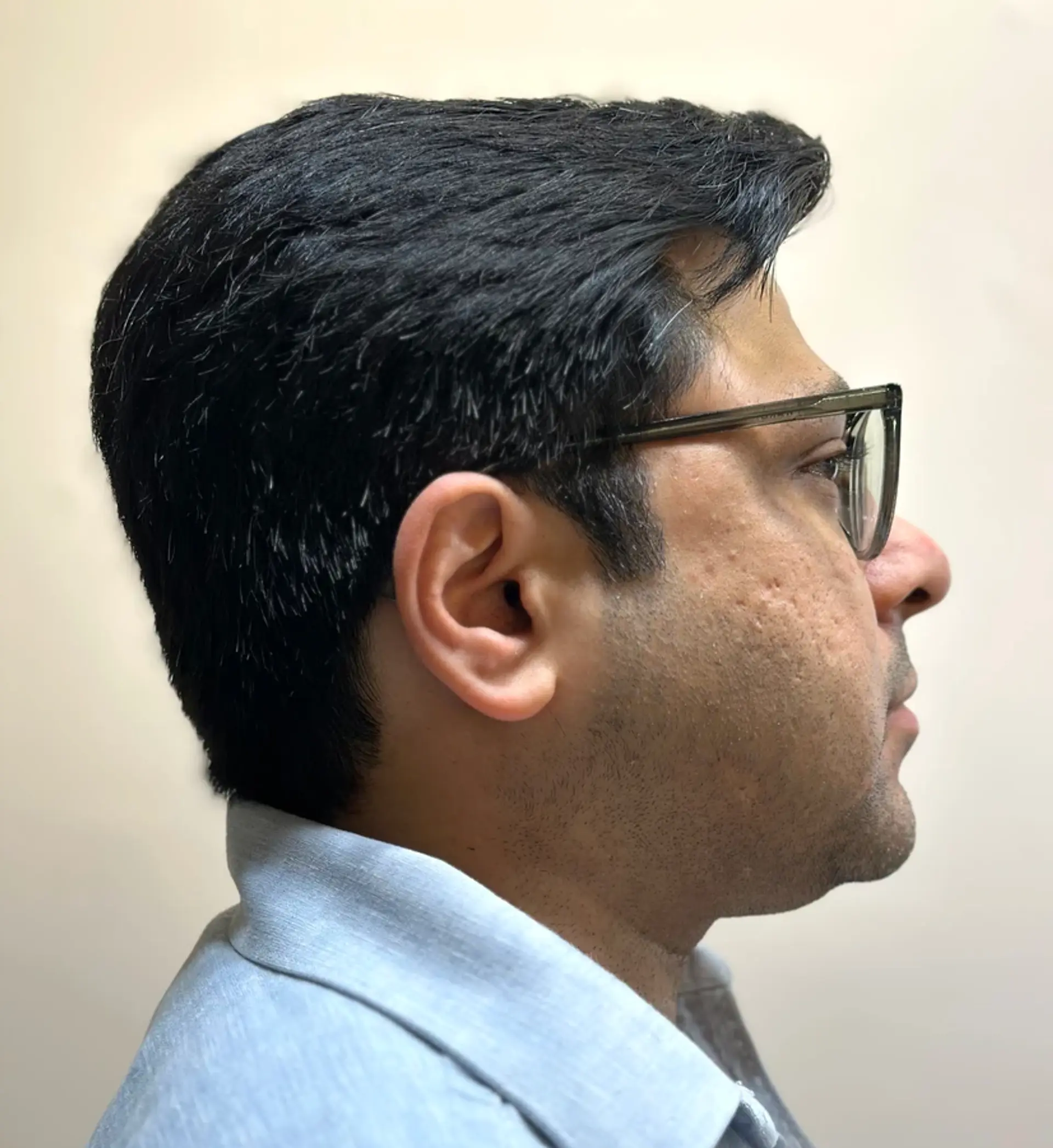 A Classic Side Part with straight, black hair styled short, featuring a neat side part and subtle volume for a professional look. 1