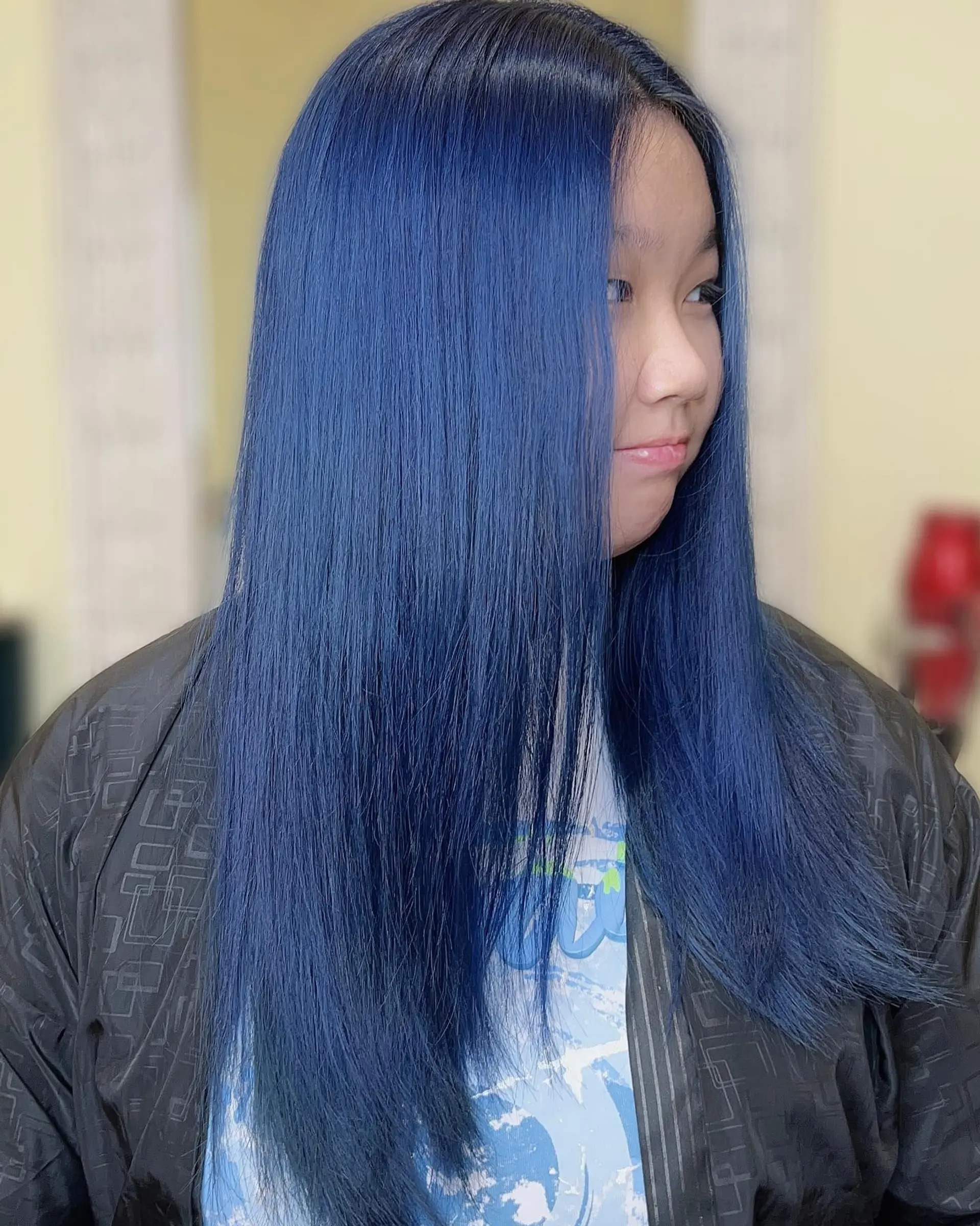 Long, straight hairstyle dyed a vivid blue color. 1
