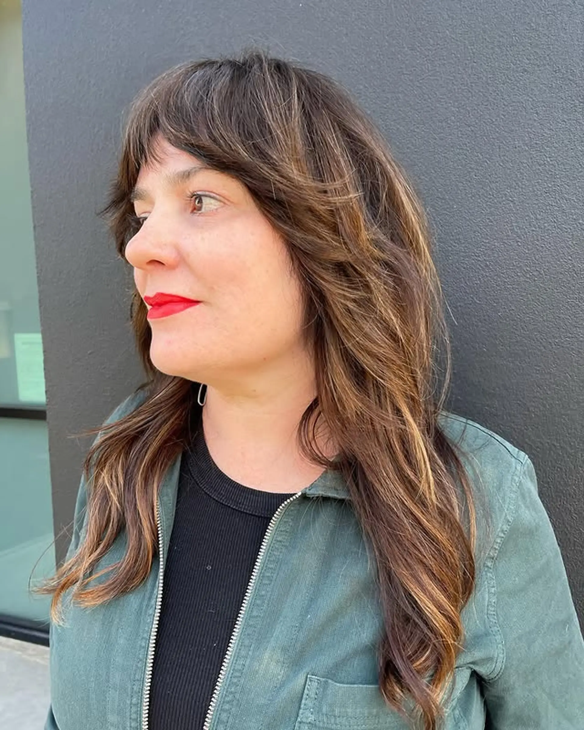 A trendy shag haircut with textured layers and face-framing curtain bangs. 1