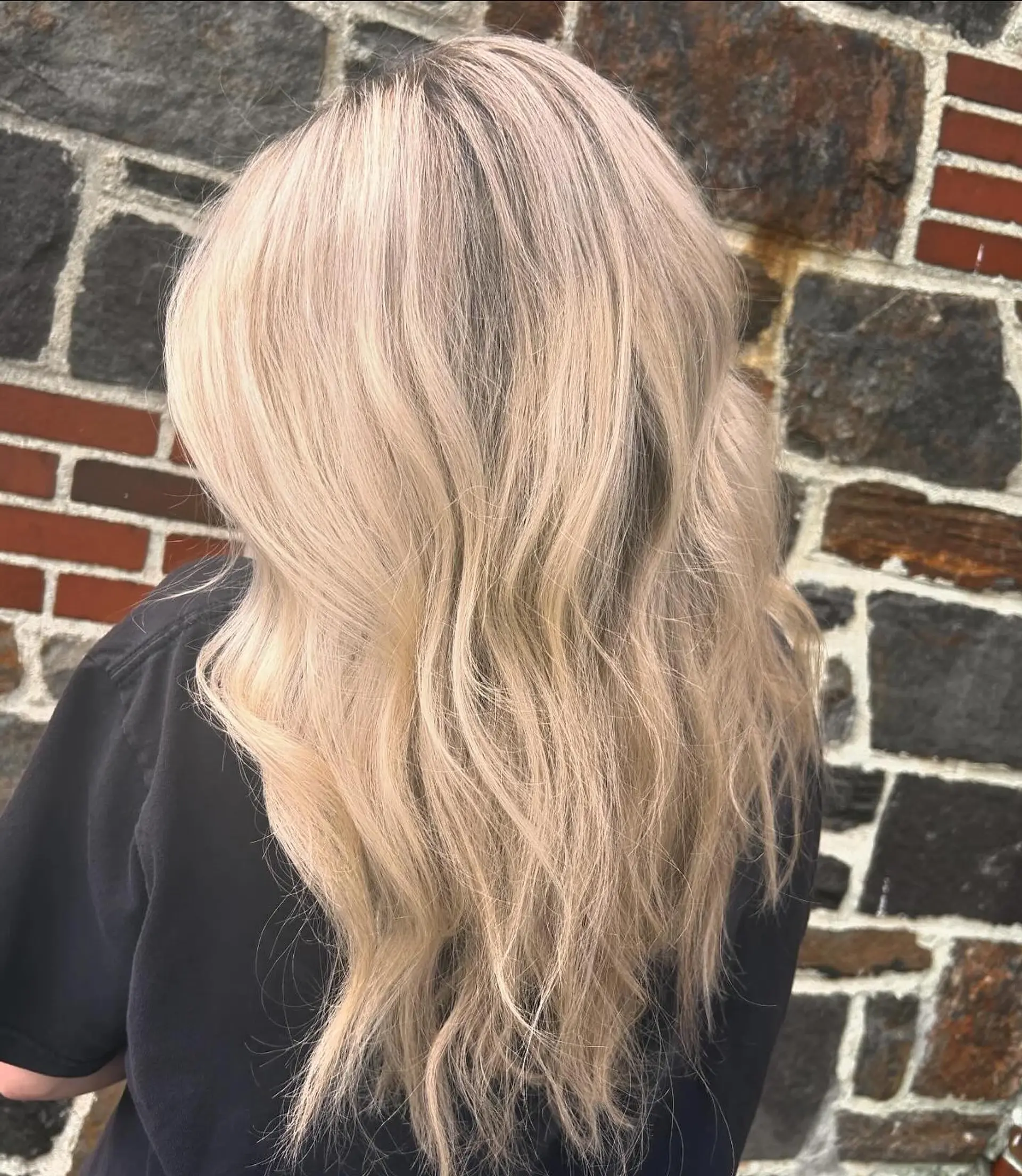 Long platinum blonde hair styled with relaxed, textured beach waves. 1