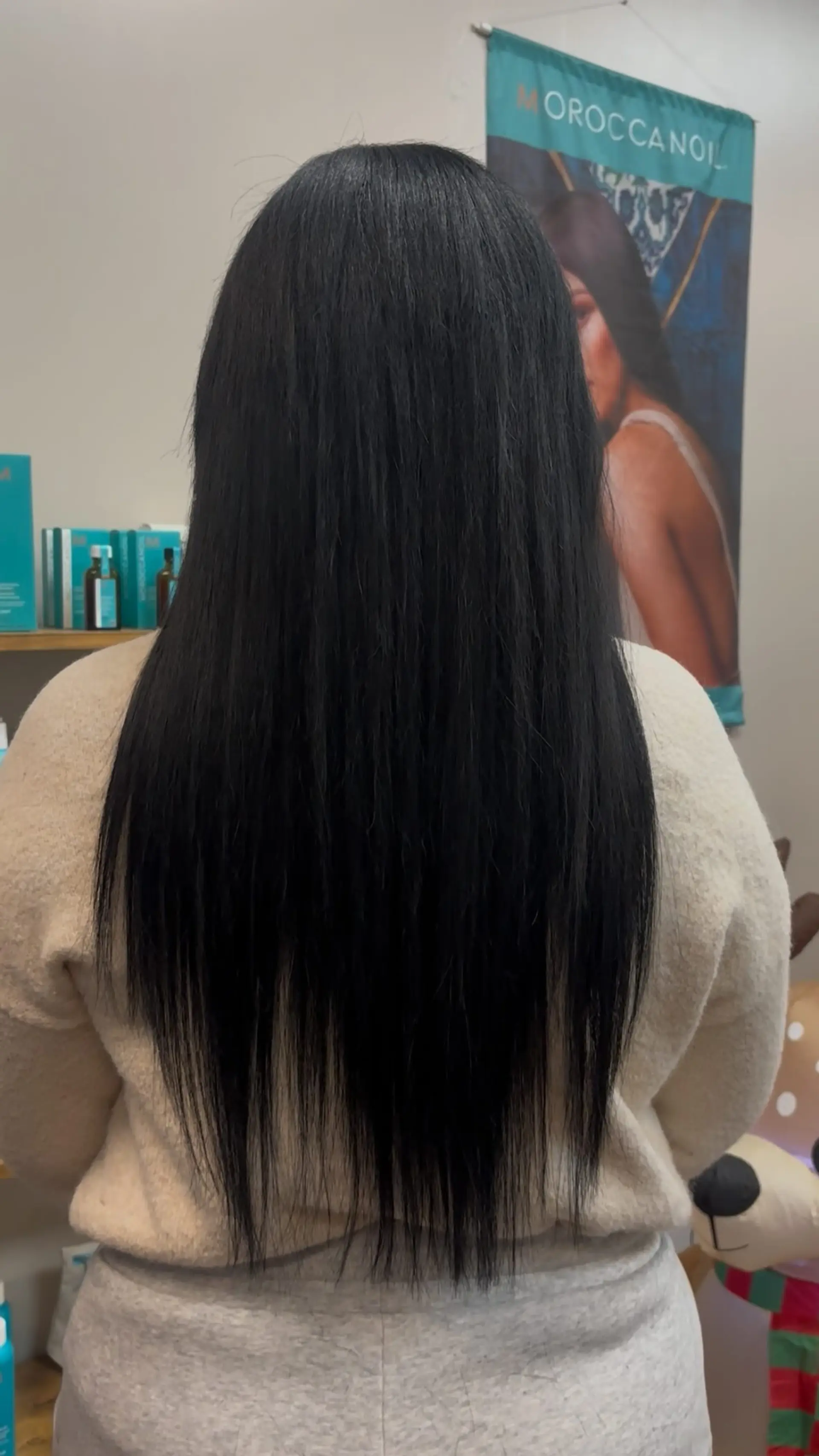 Long, sleek jet-black hair styled straight down the back with textured, wispy ends. 1