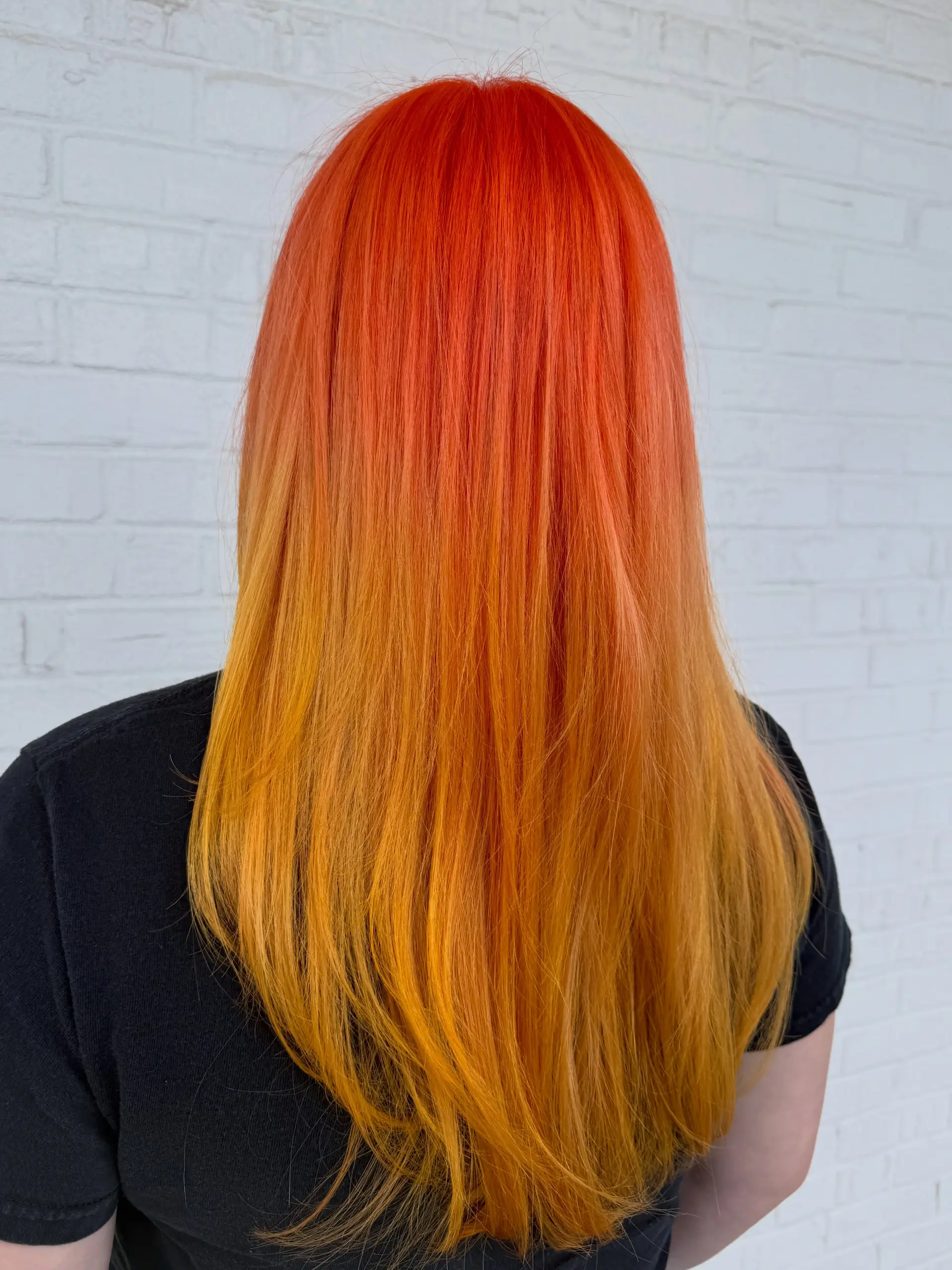 Long straight hair featuring a vivid ombre gradient shifting from bright fiery orange at the roots to warm golden yellow at the ends. 1