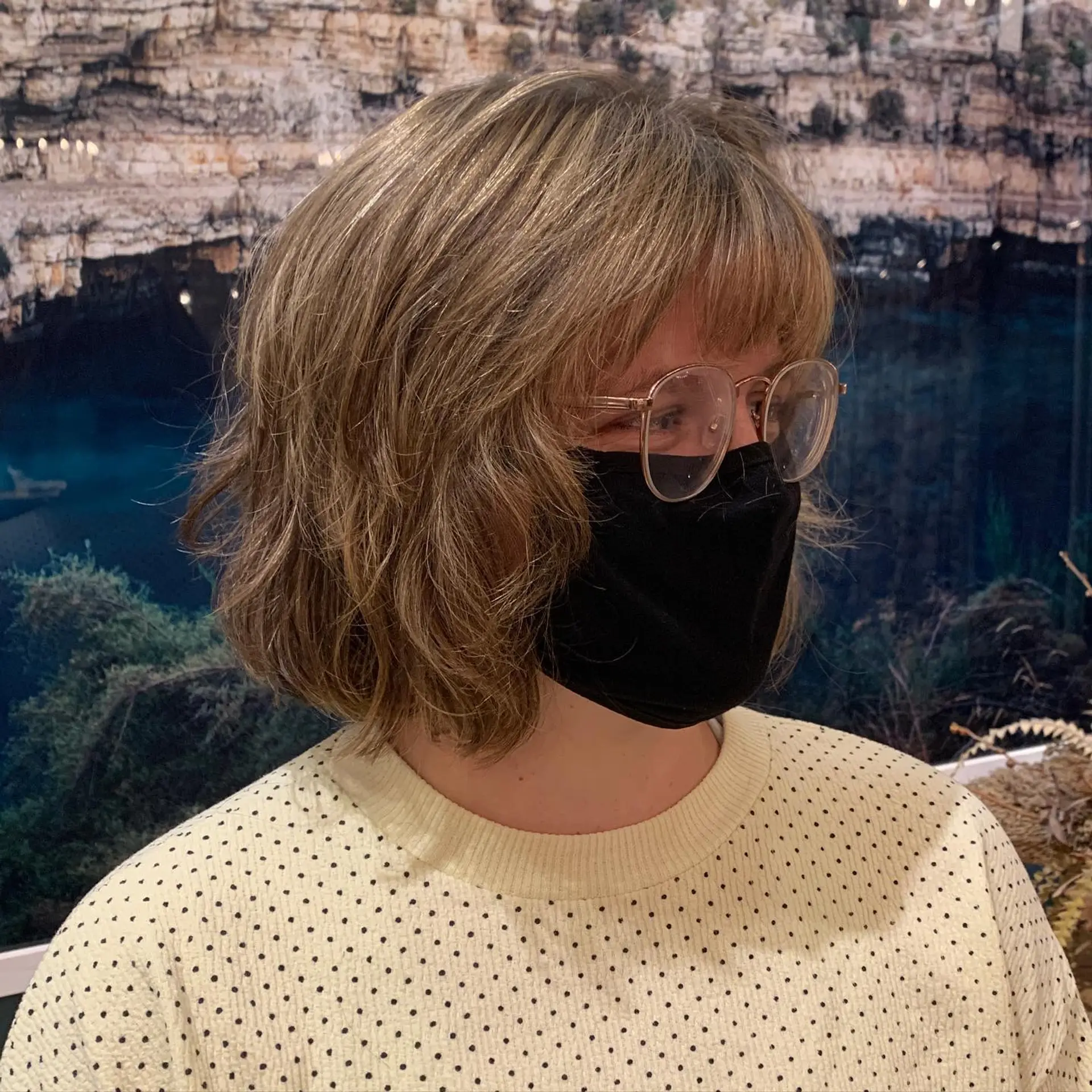 A trendy medium-length, layered bob with baby bangs and a textured finish. 1